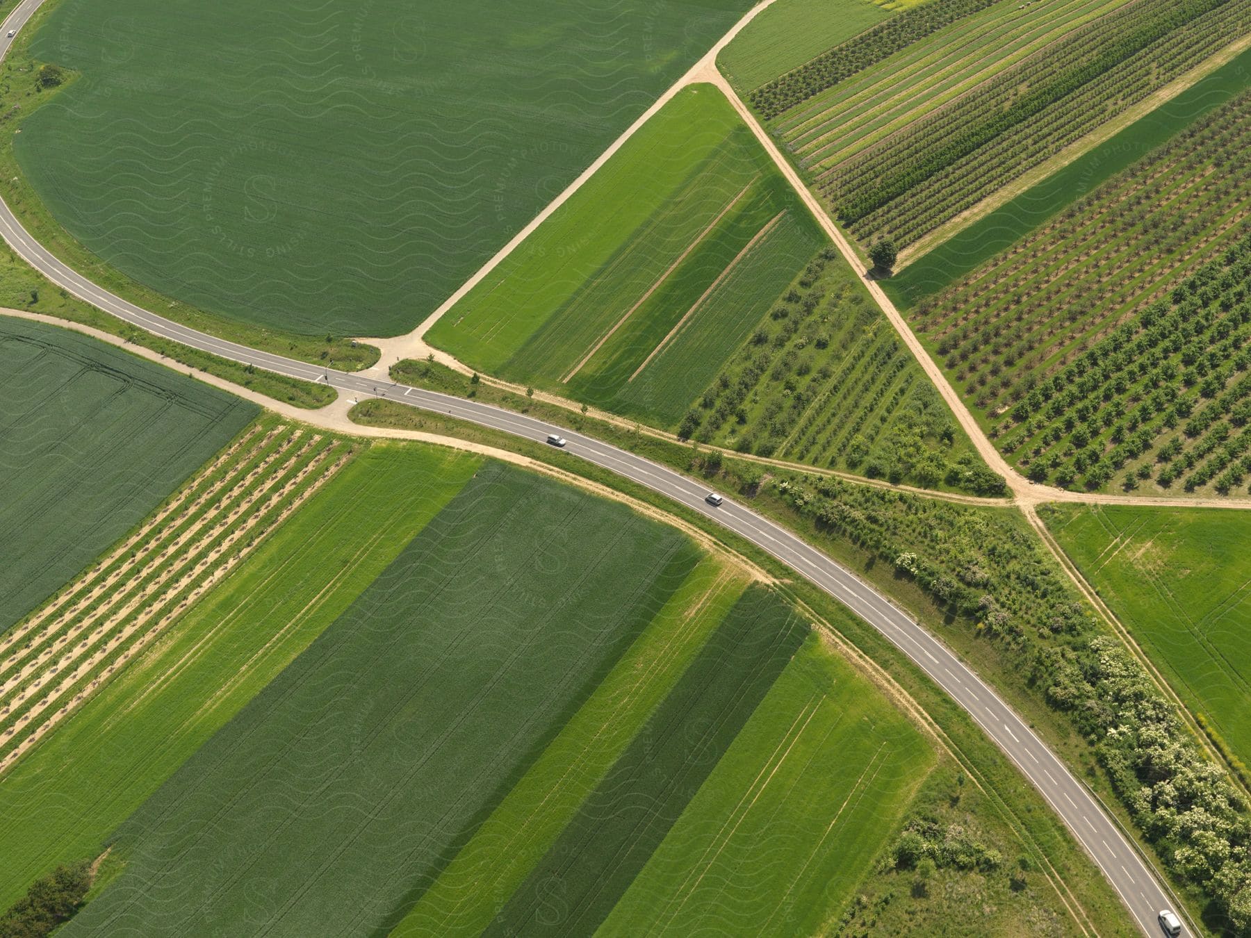 Aerial view of farming land with a highway and cars