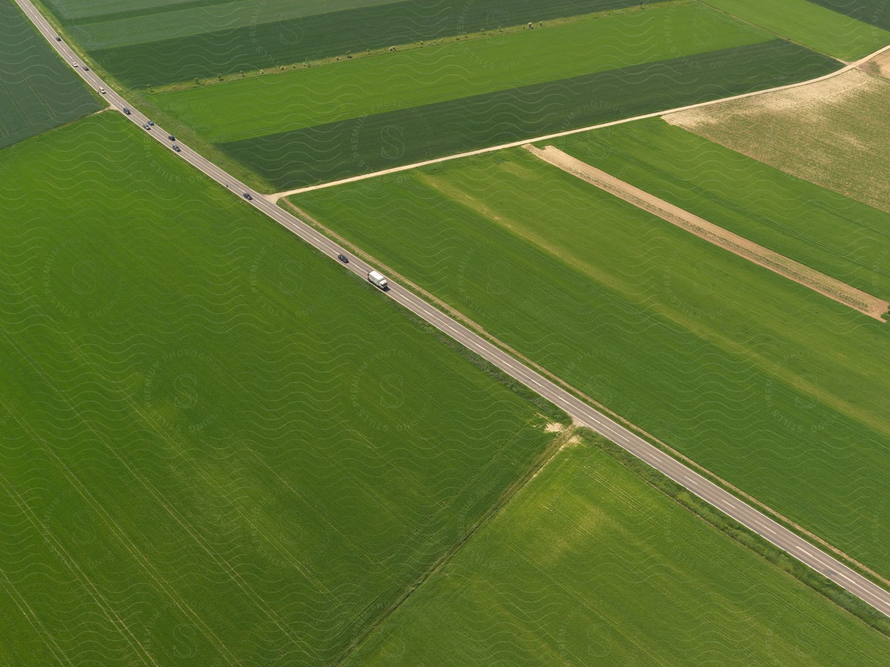 A car drives on a highway through a rural countryside