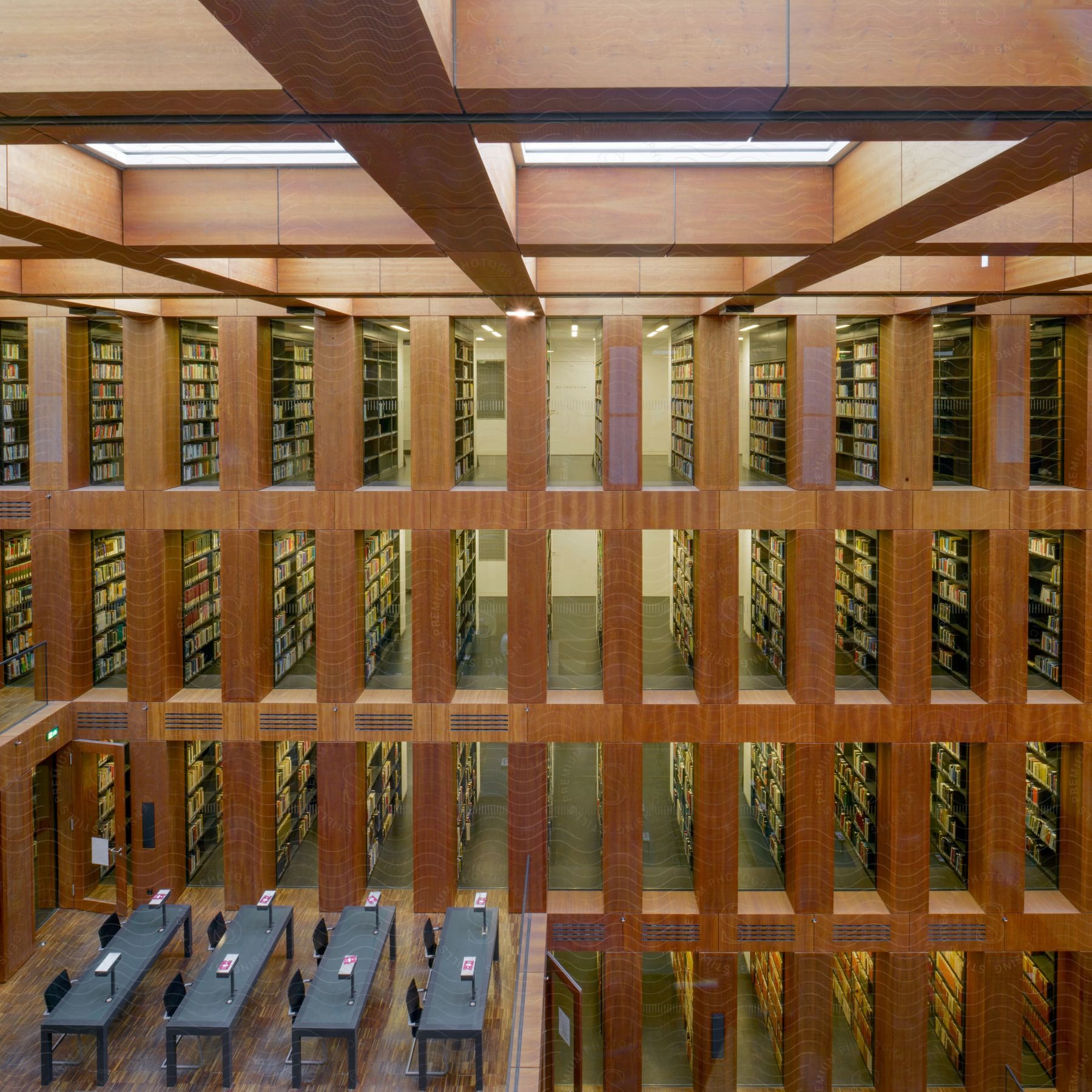 An empty wine cellar with wooden shelving and a floor