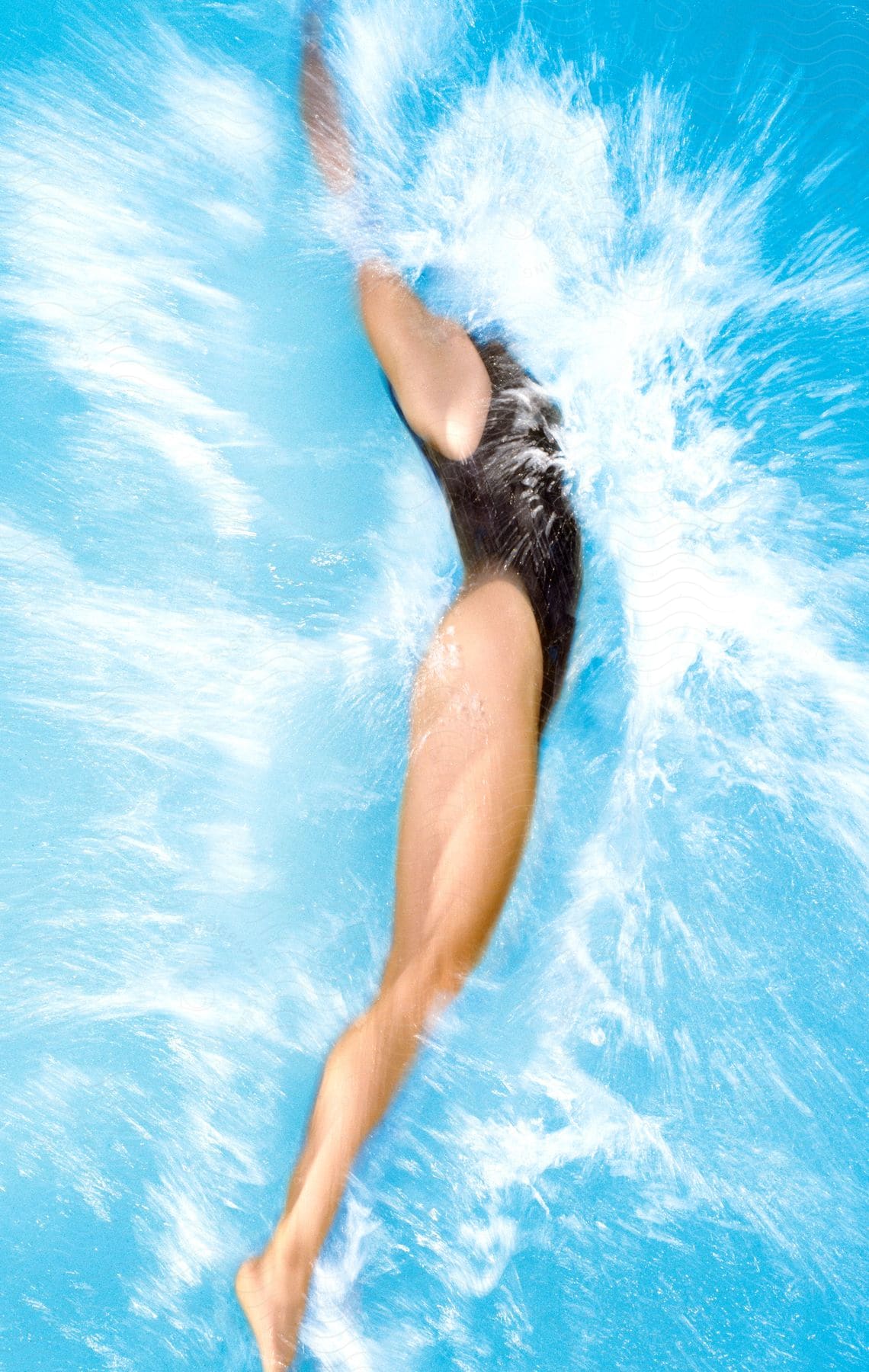 A woman swimming in a pool in the afternoon with swimwear