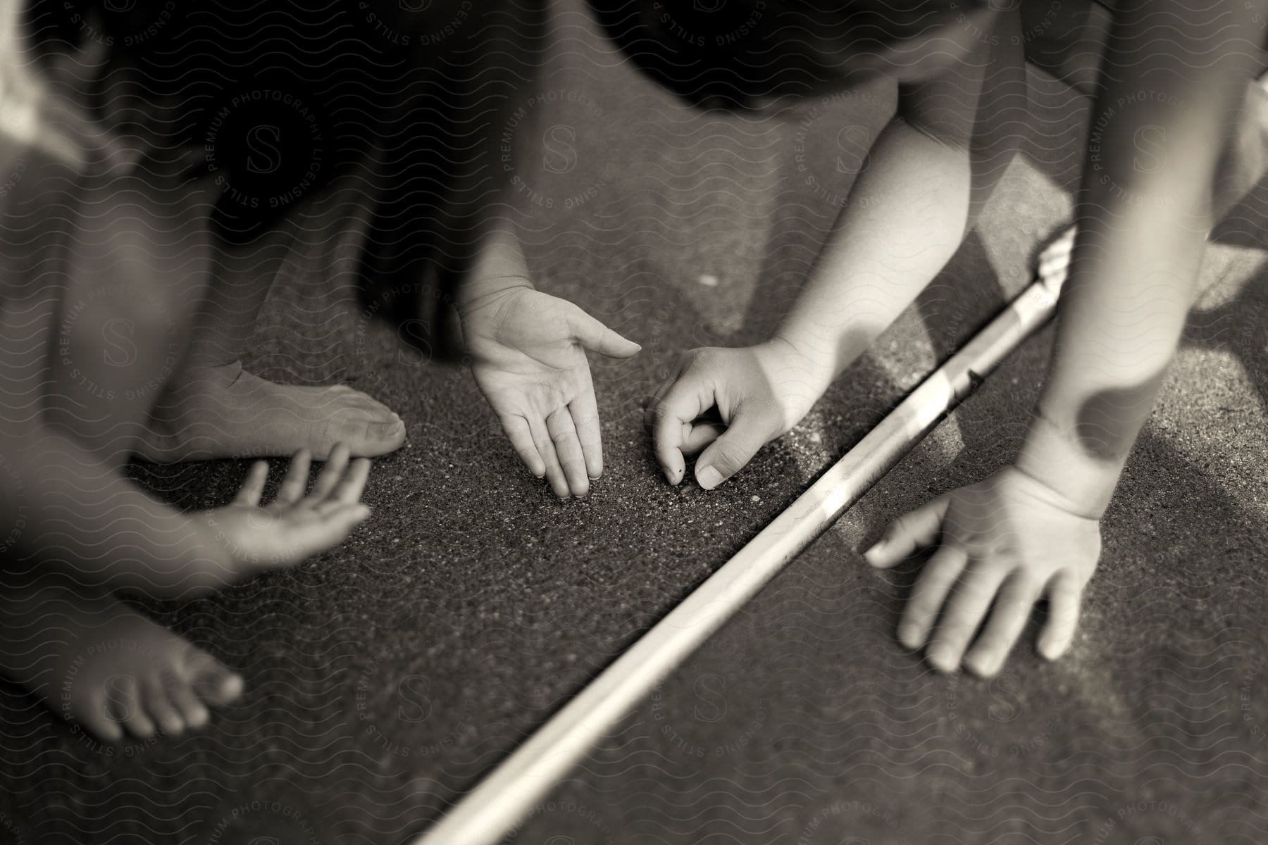 Children Picking Up Something From The Floor