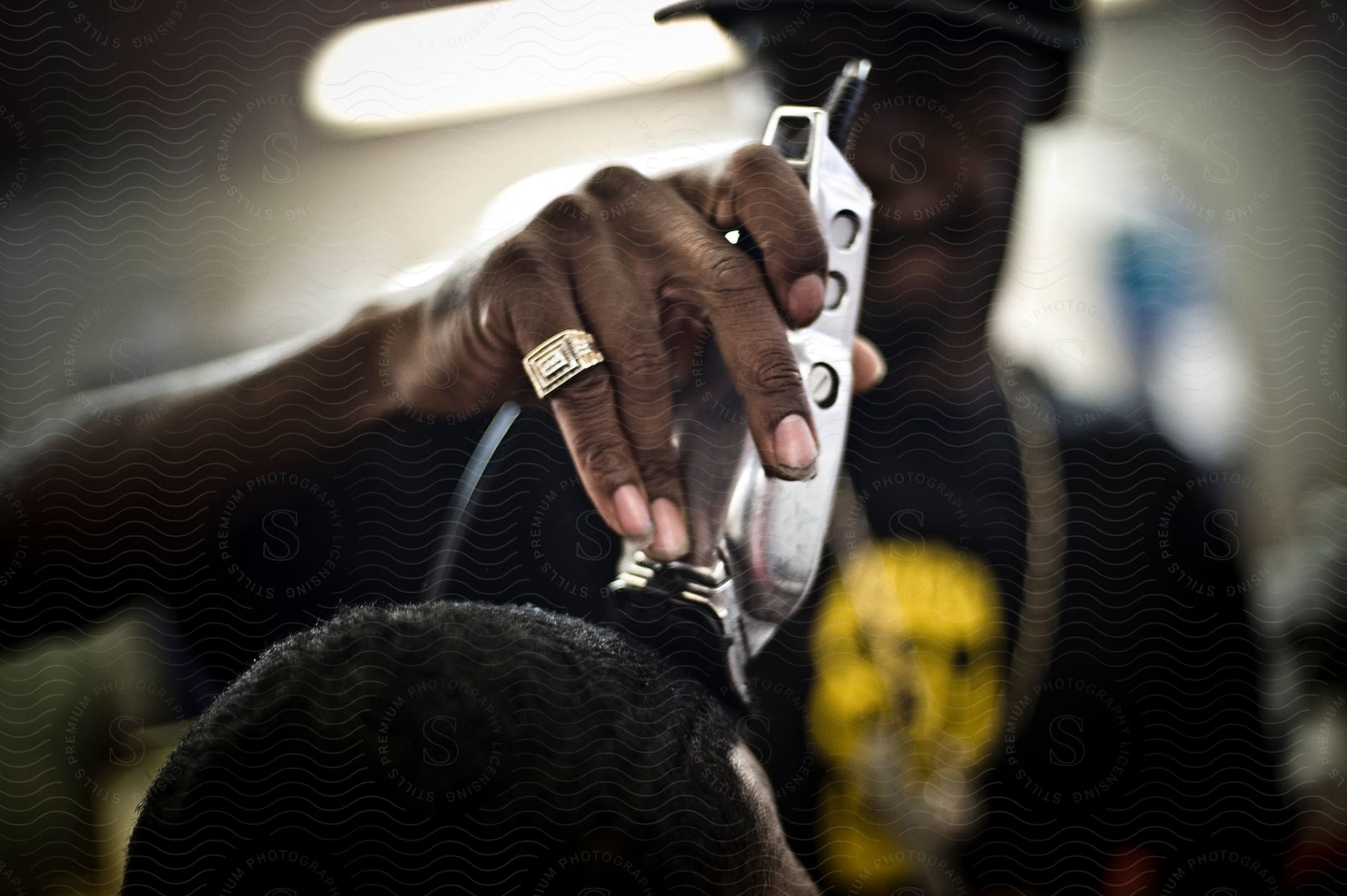 A barber uses electric clippers on a customers head in a las vegas barbershop