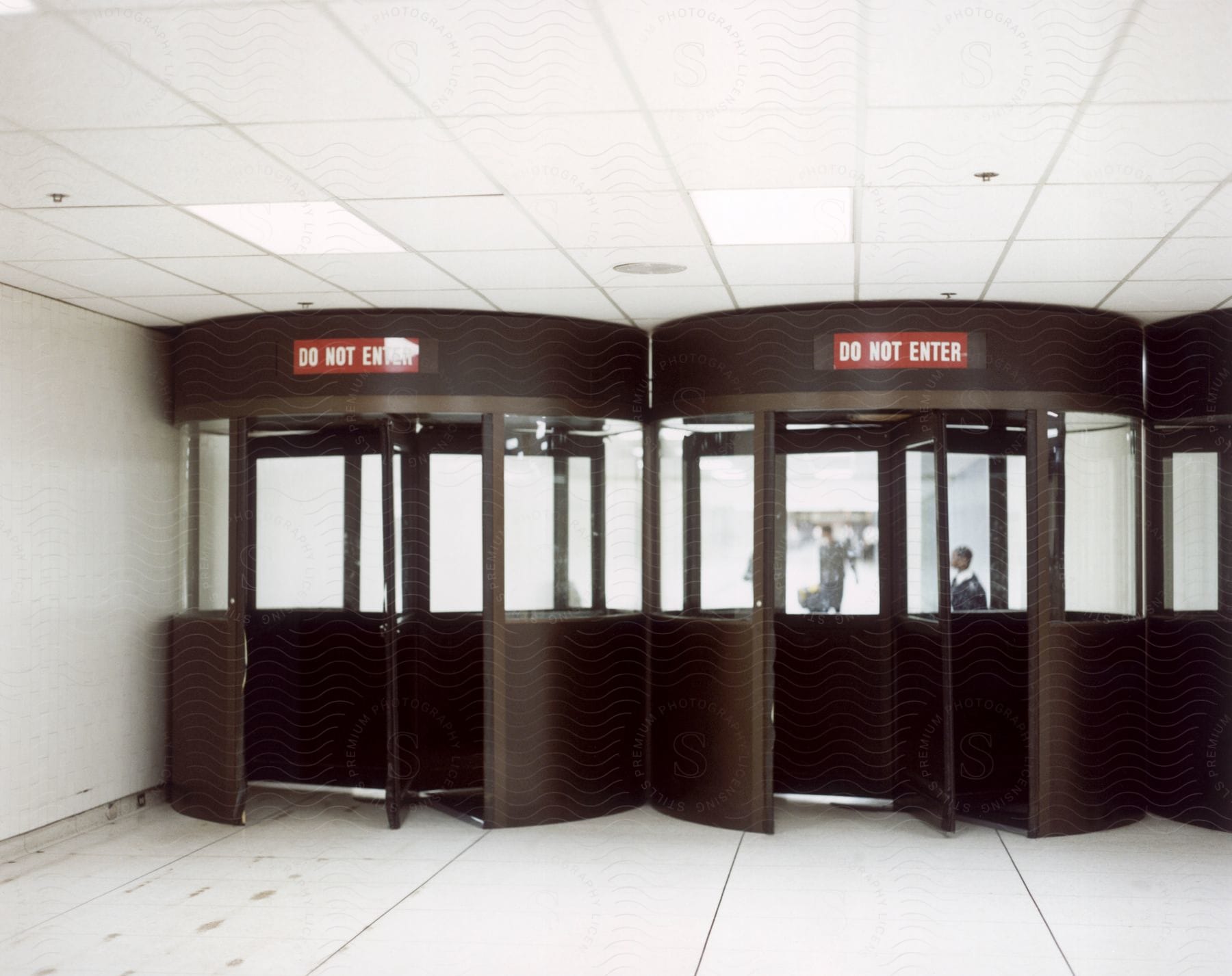 A door leading to an office with a security standing outside