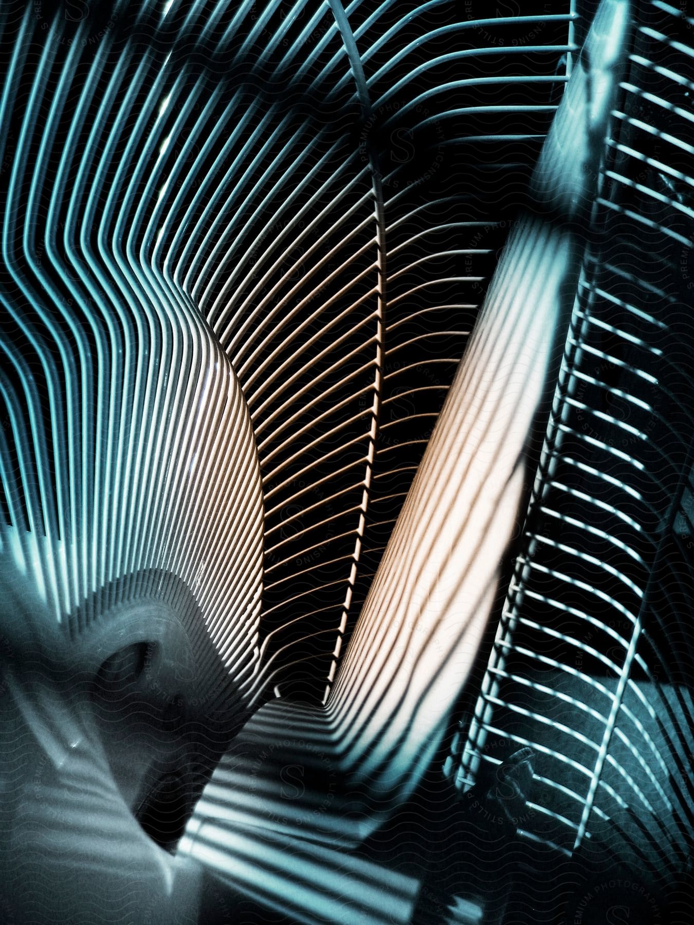 An indoor closeup photograph of a single electric fan