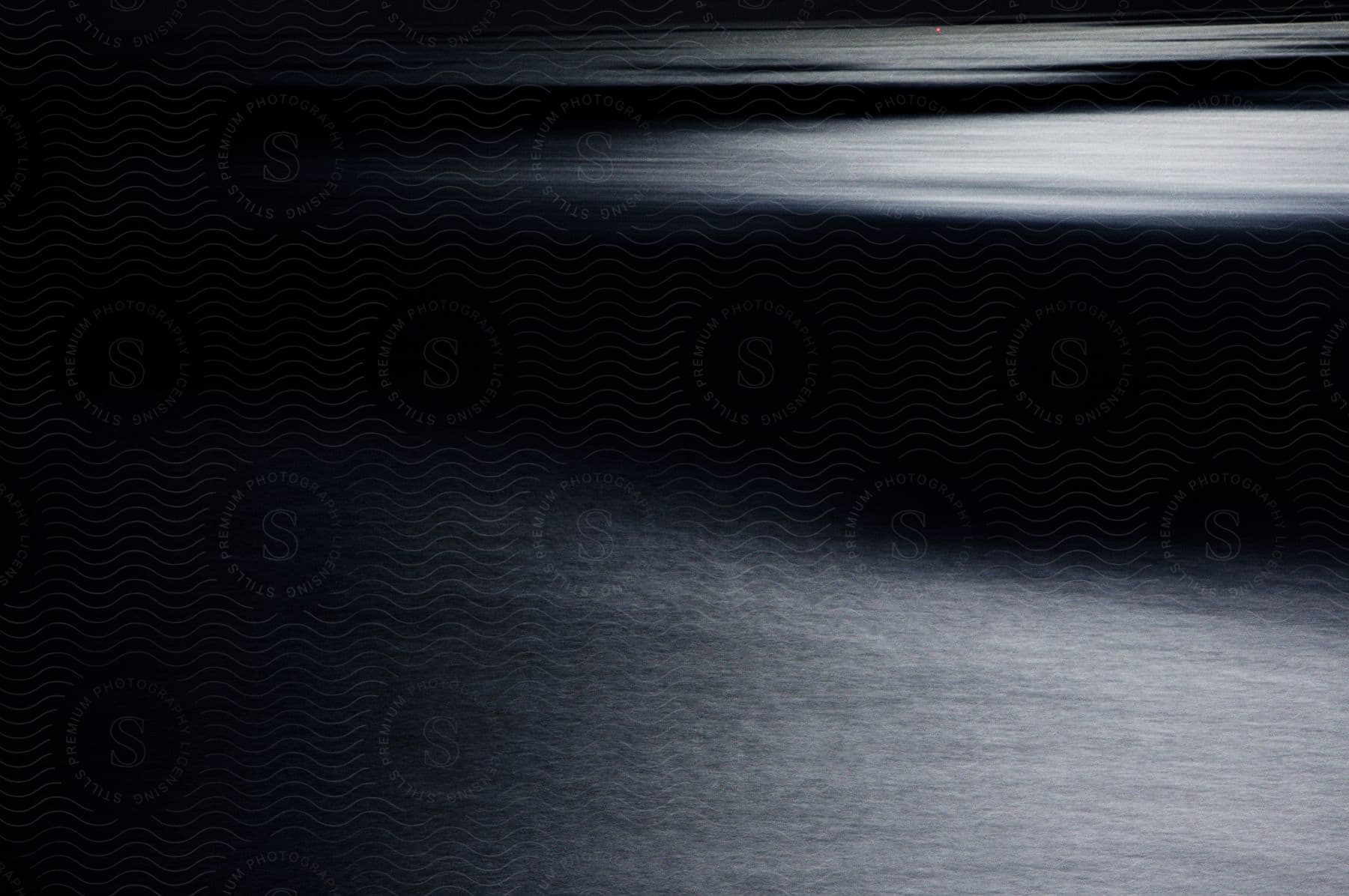 A digital photo of a black surface with a grey texture