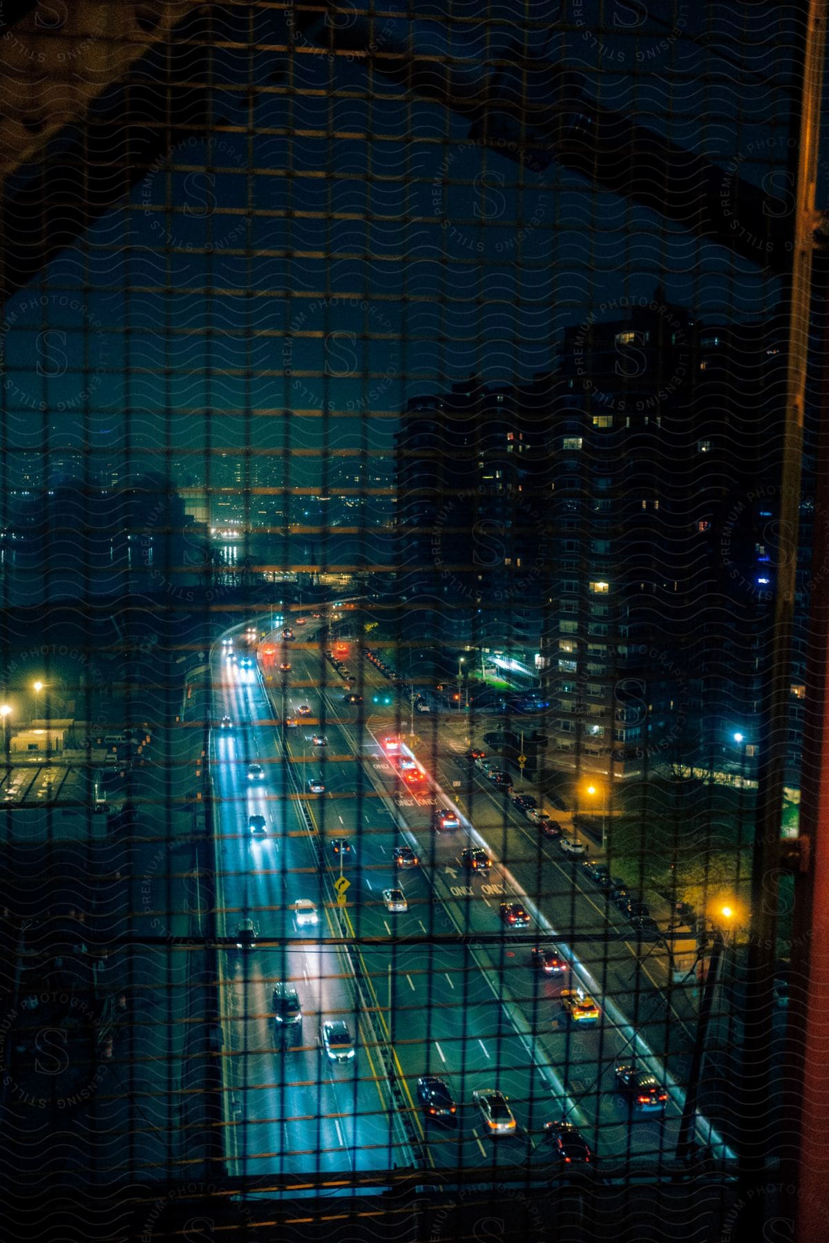 A cityscape at night with a freeway buildings and street lights