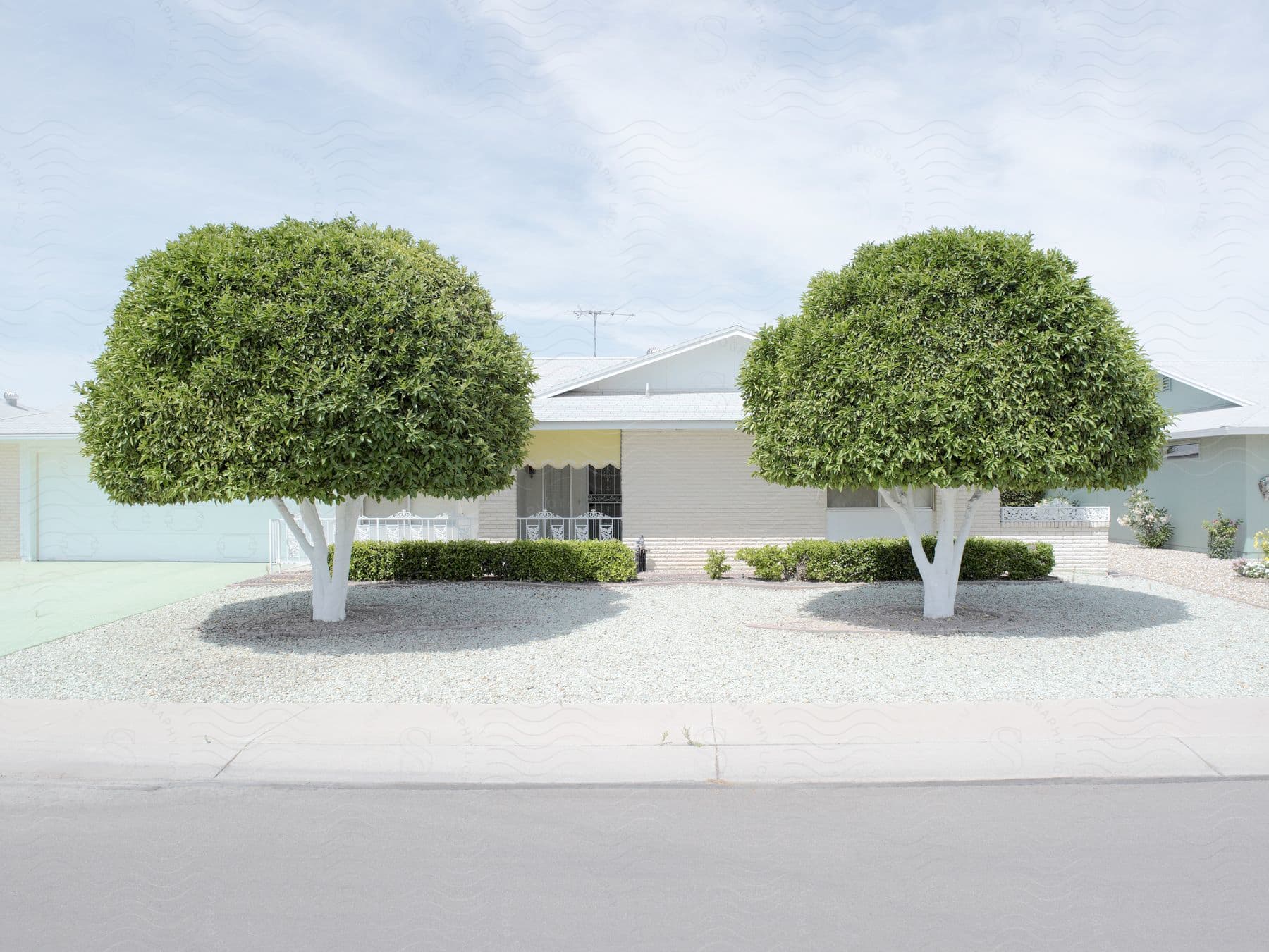 A well structured house with two trees in the front