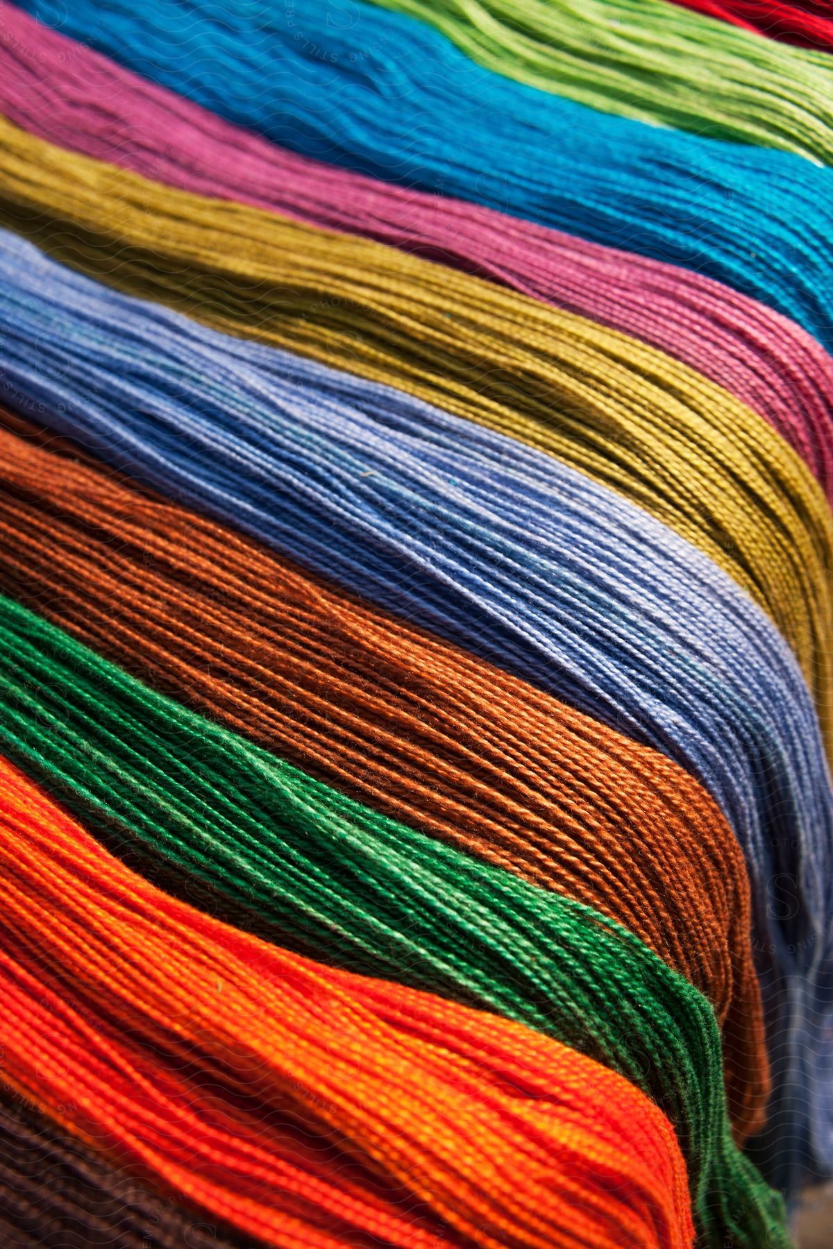 Embroidery thread in various colors draped over objects