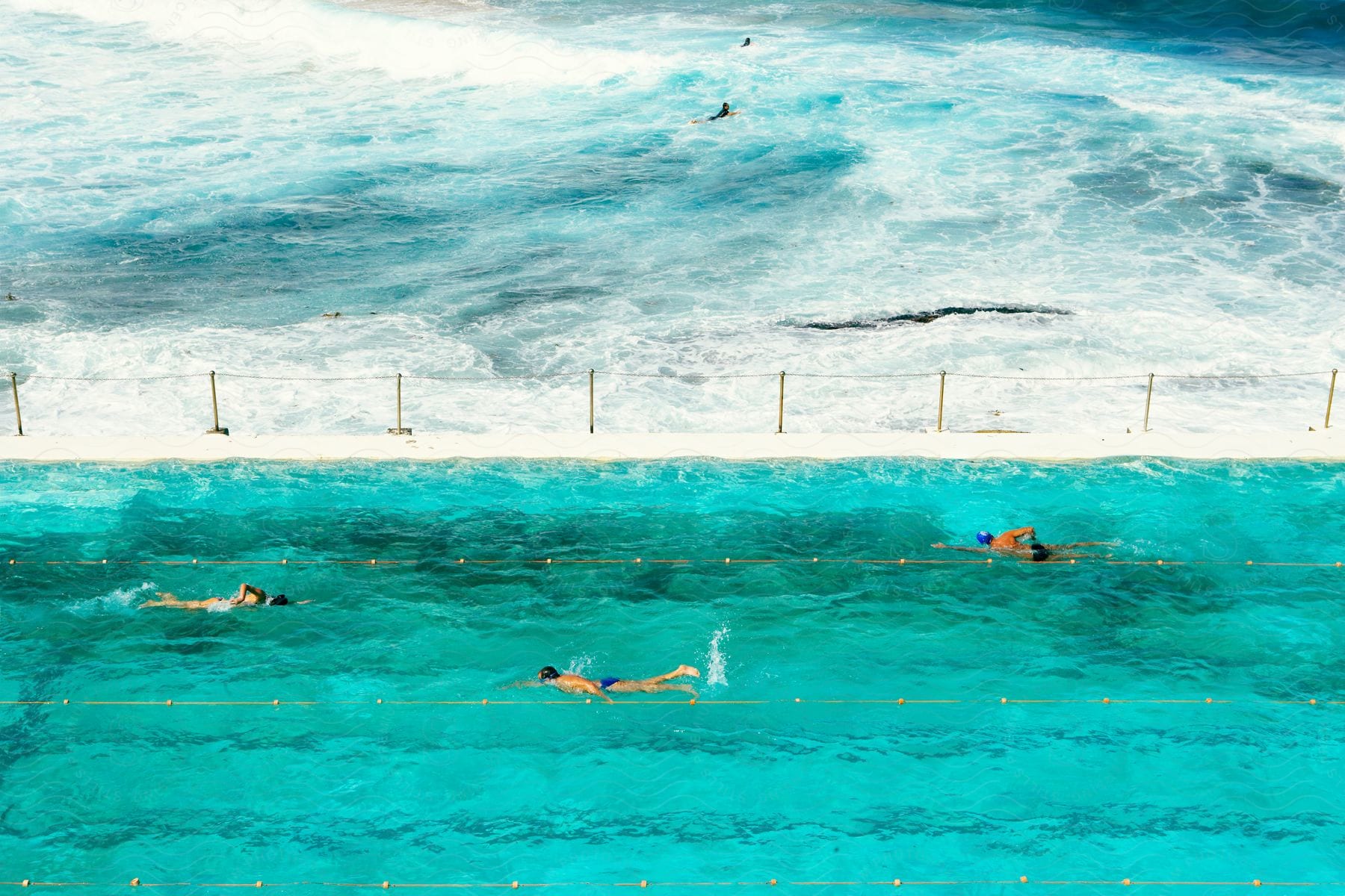 Three people swimming at a beach