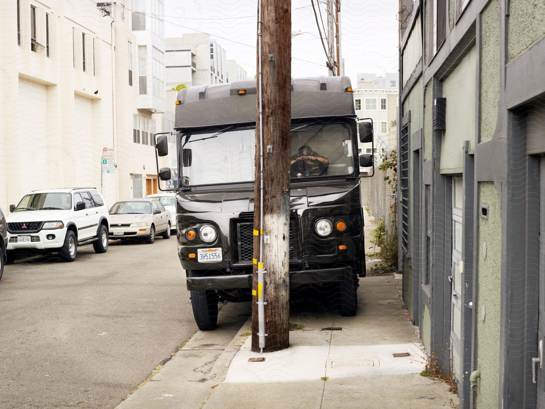 A man sleeping in a package delivery truck in san francisco during the day