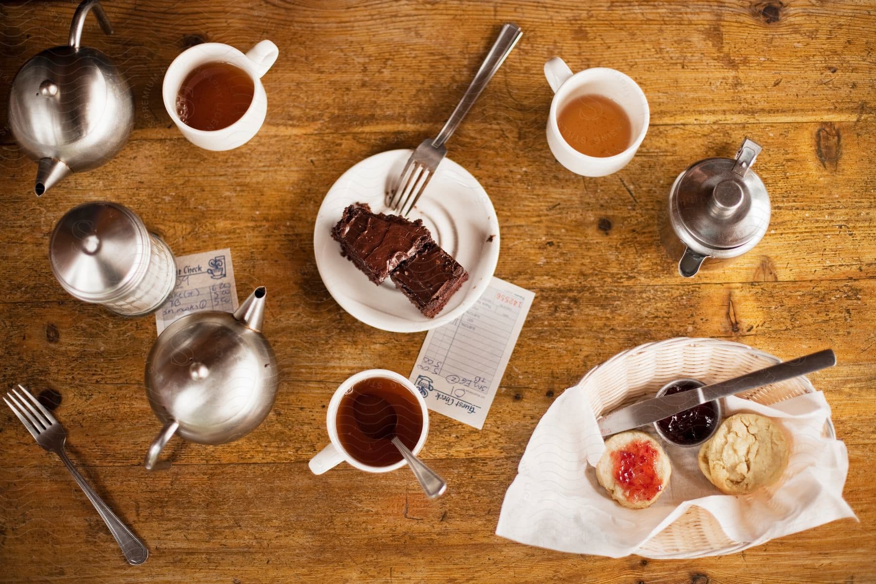 Breakfast table with chocolate cake and tea on a wooden table