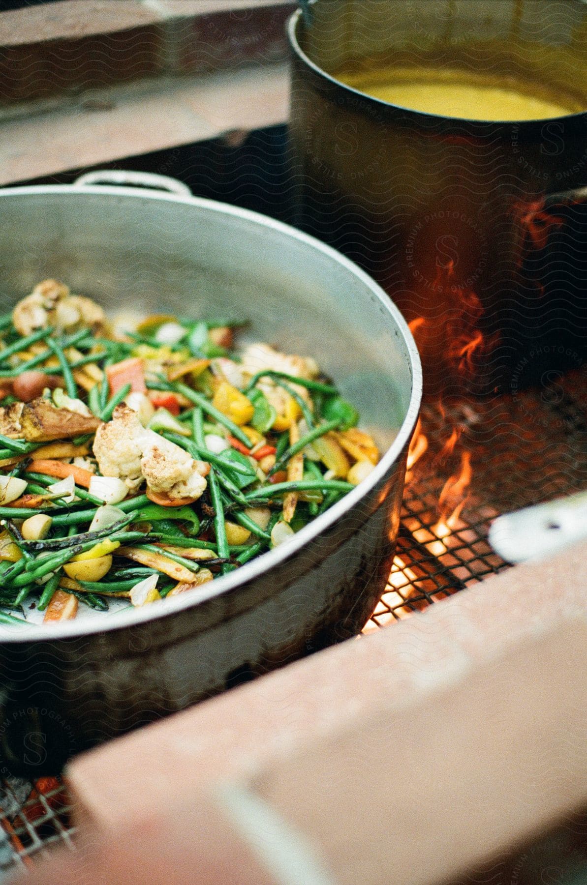Food being cooked on a stove top with flames