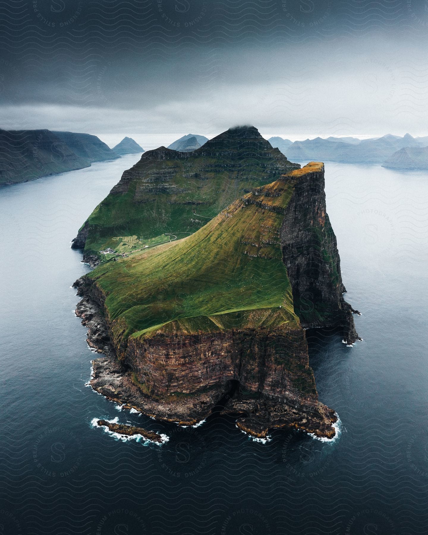 A serene coastal landscape with mountains cliffs and water