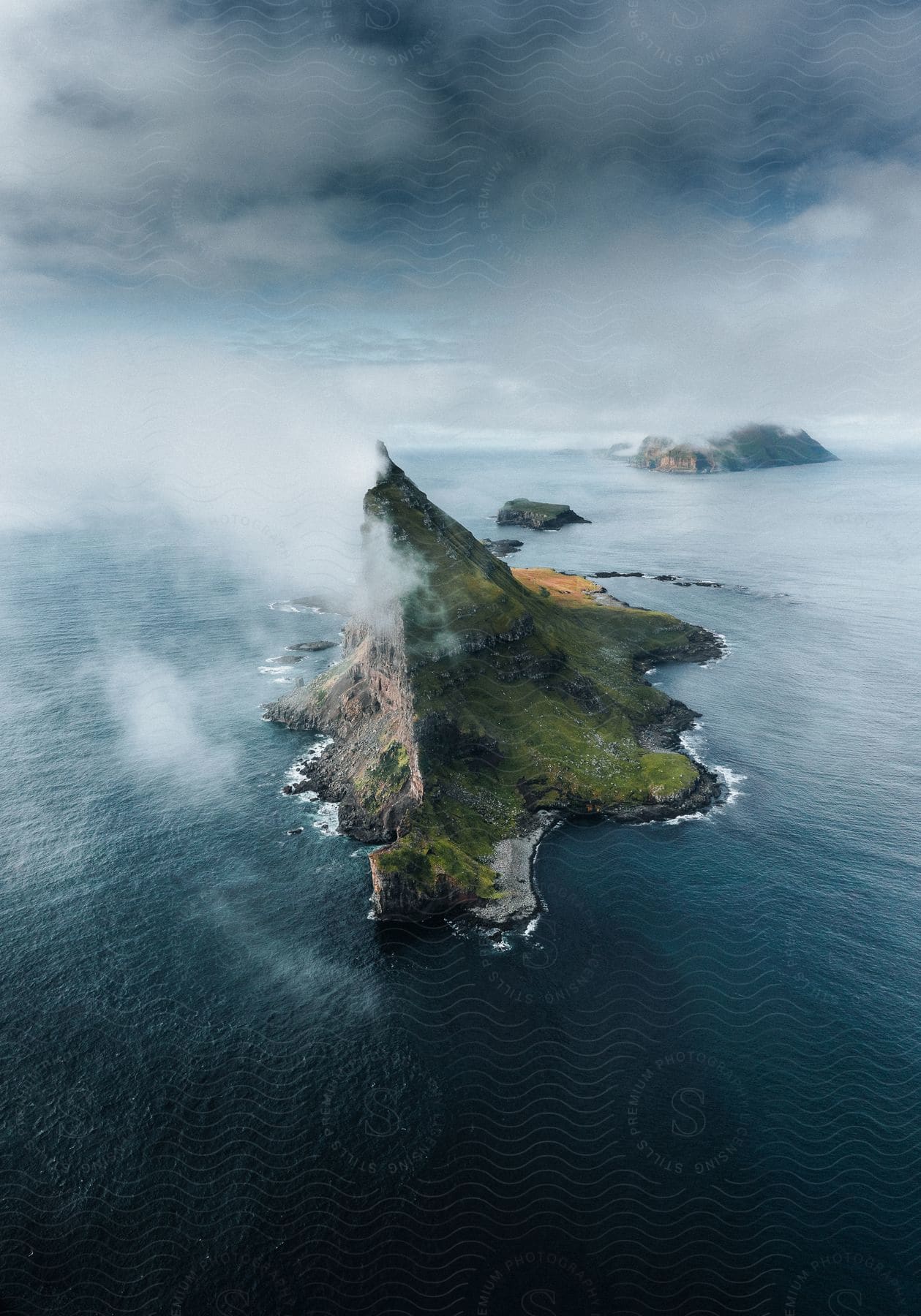 Aerial Shot Of Sea Stack And Land Formations Over The Sea