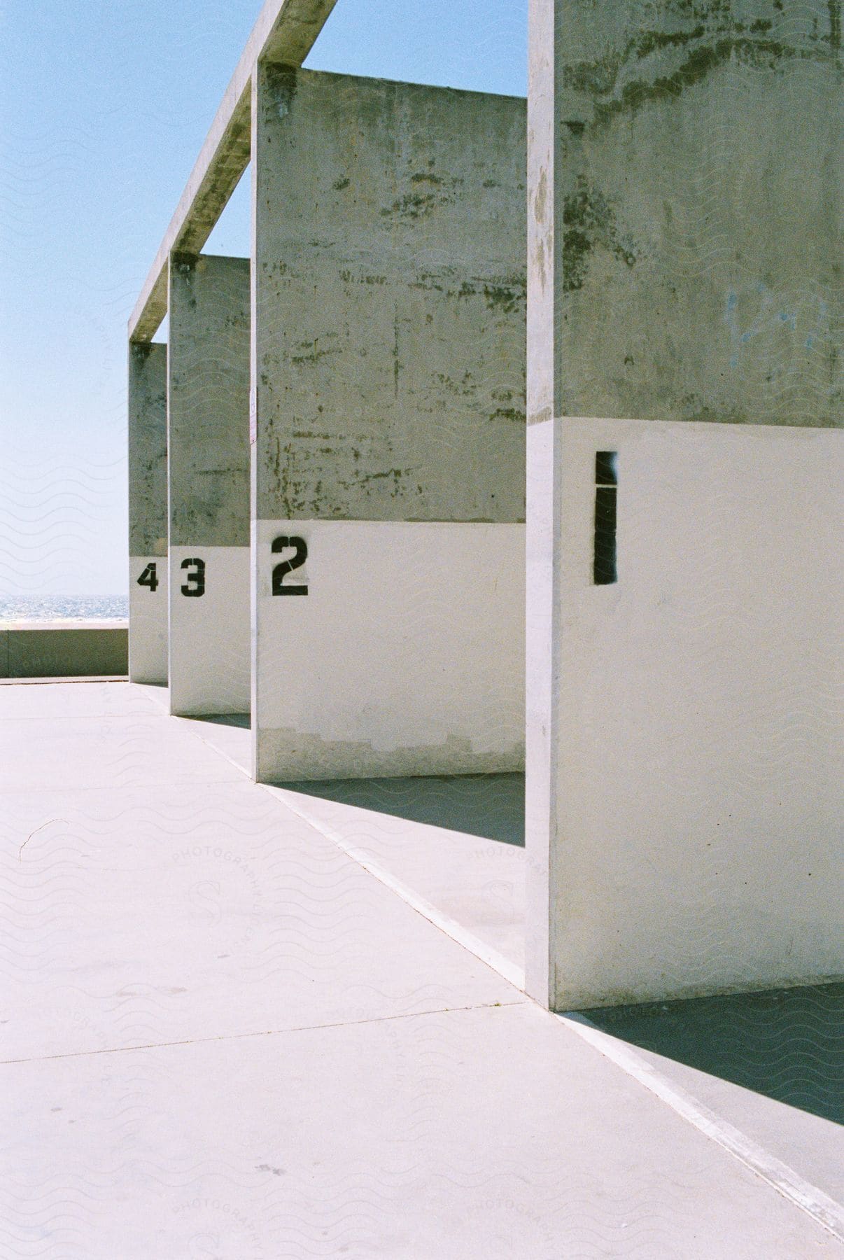 Green and white outdoor racquetball courts located near the beach