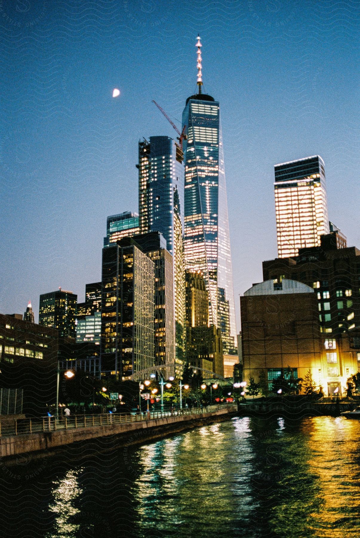 Bright waterfront skyline seen from the water at night