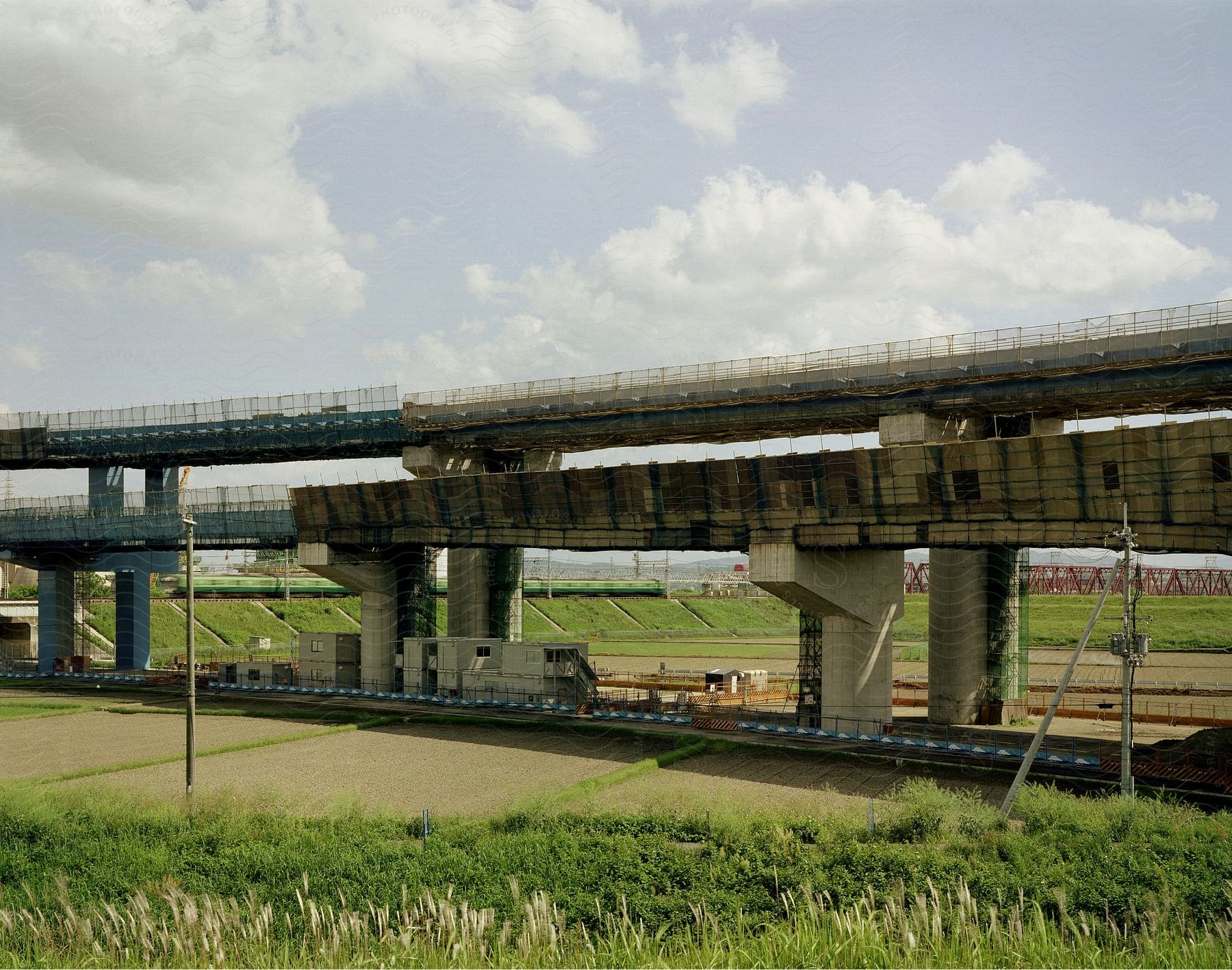 A concrete bridge crossing green vegetation
