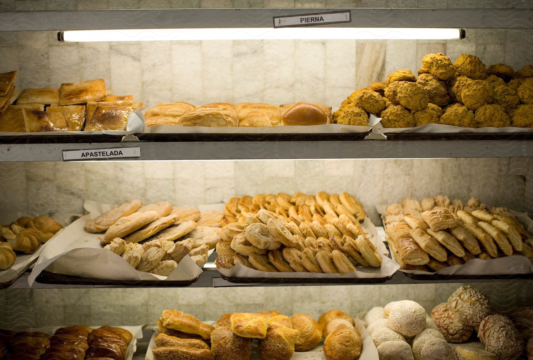 Different types of breads and pastries on a 3tier bread display stand