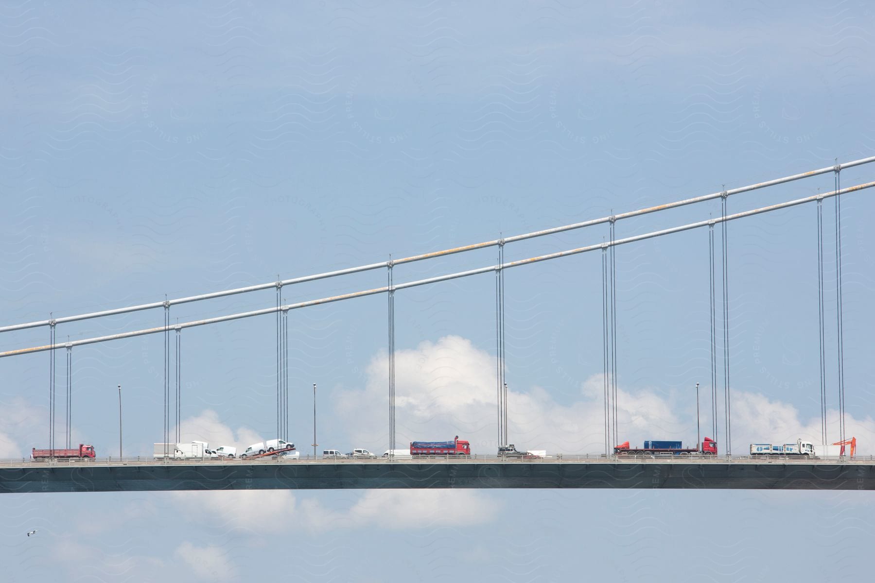 A long bridge with cars stuck in traffic congestion crossing the bosphorus river from europe to asia in istanbul turkey