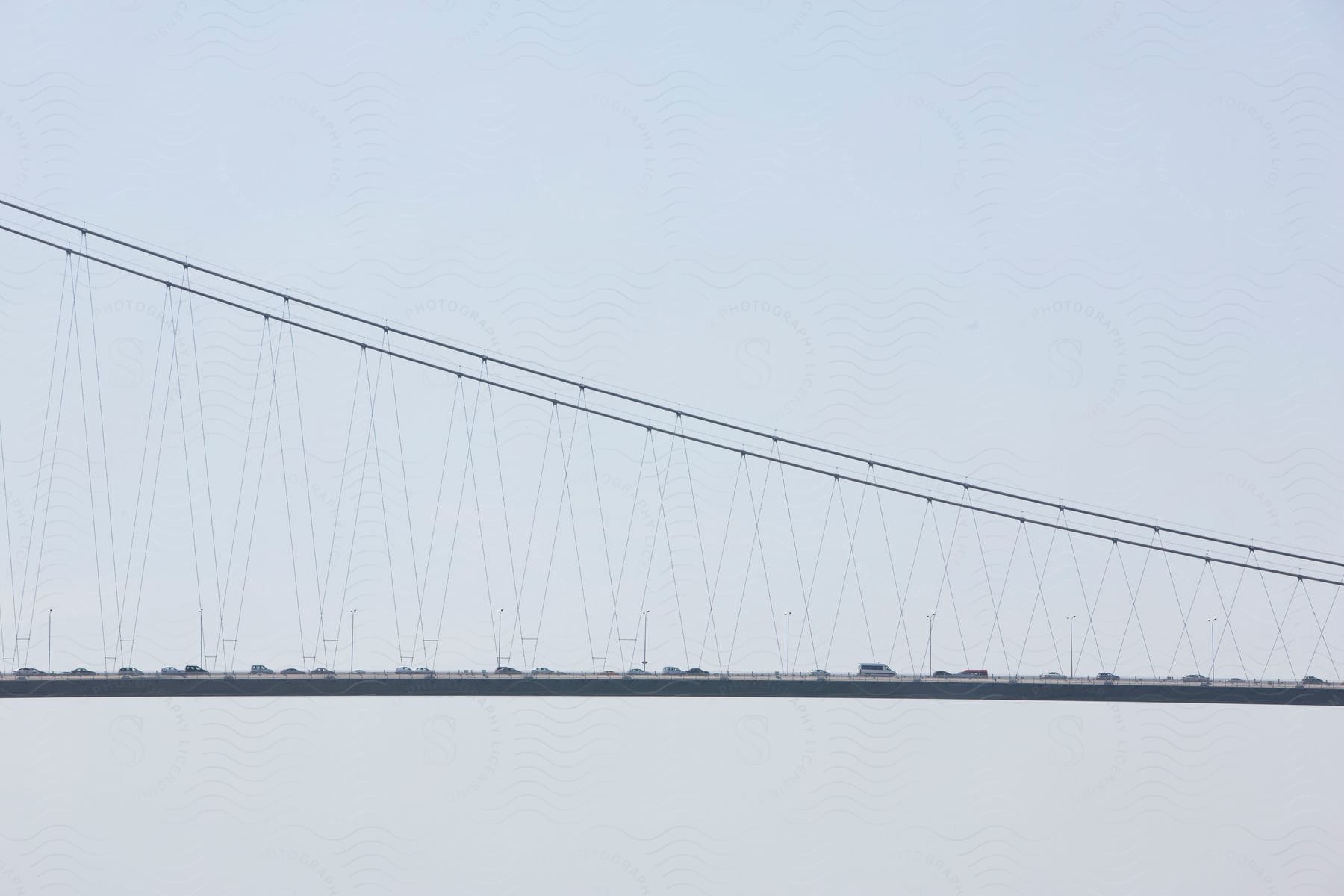 Cars cross a suspension bridge over the bosphorus river from europe to asia in istanbul turkey