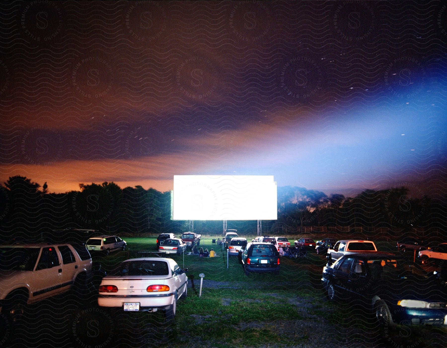 A group of cars parked outdoors in a field