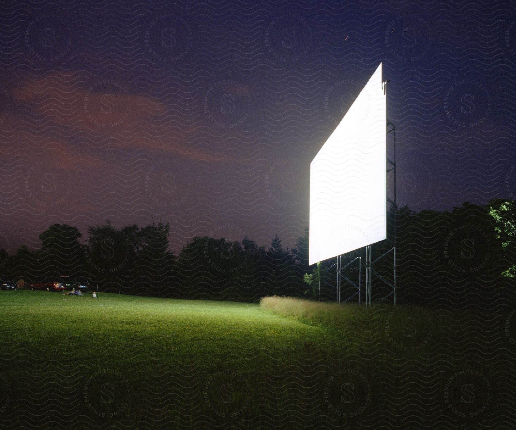 A drivein theater with a litup screen