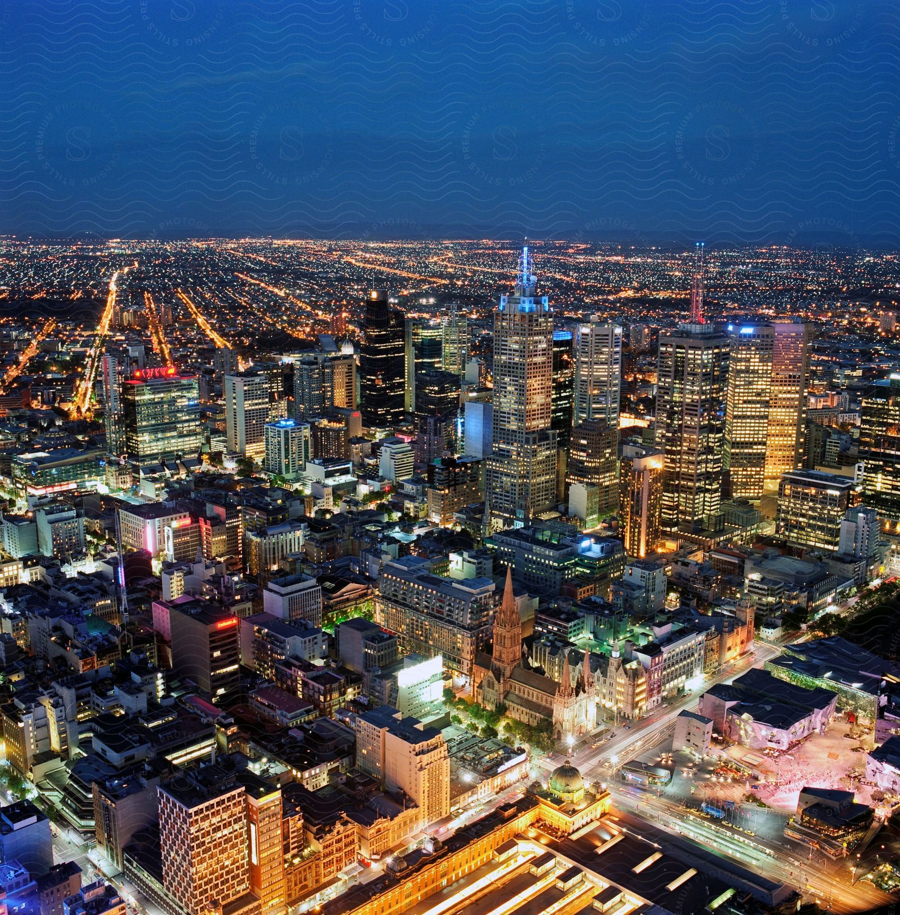 Metropolis with lighted buildings skyscrapers and street lights at night