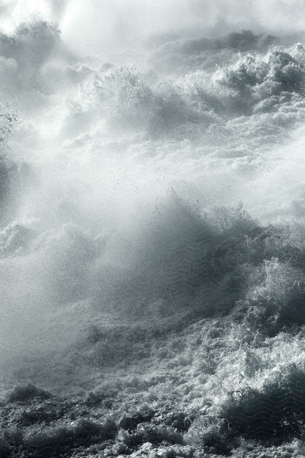 Colossal ocean waves rise and surge with aweinspiring might in a blackandwhite photograph