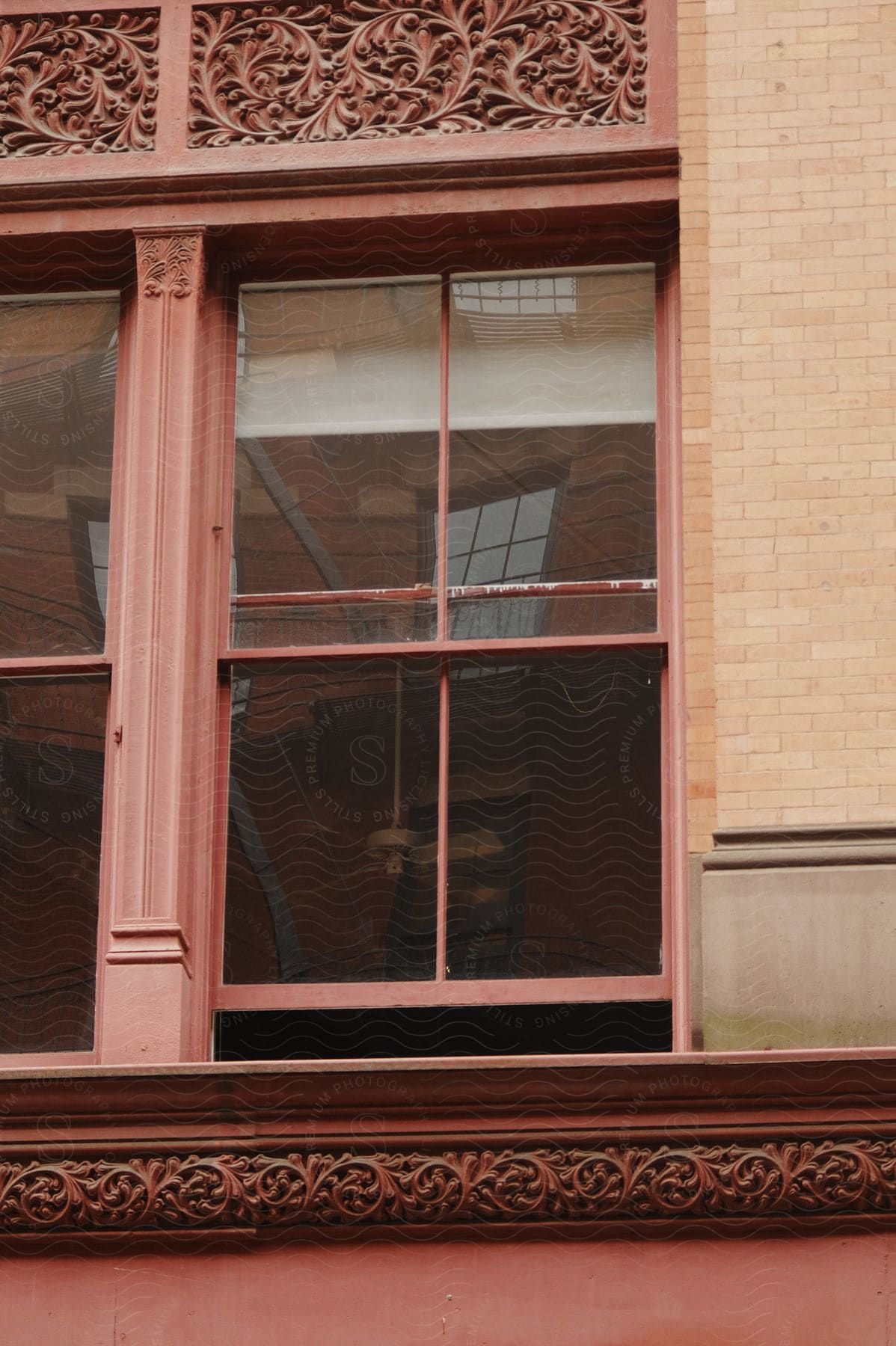 An old window of a building is shown with the window slightly ajar