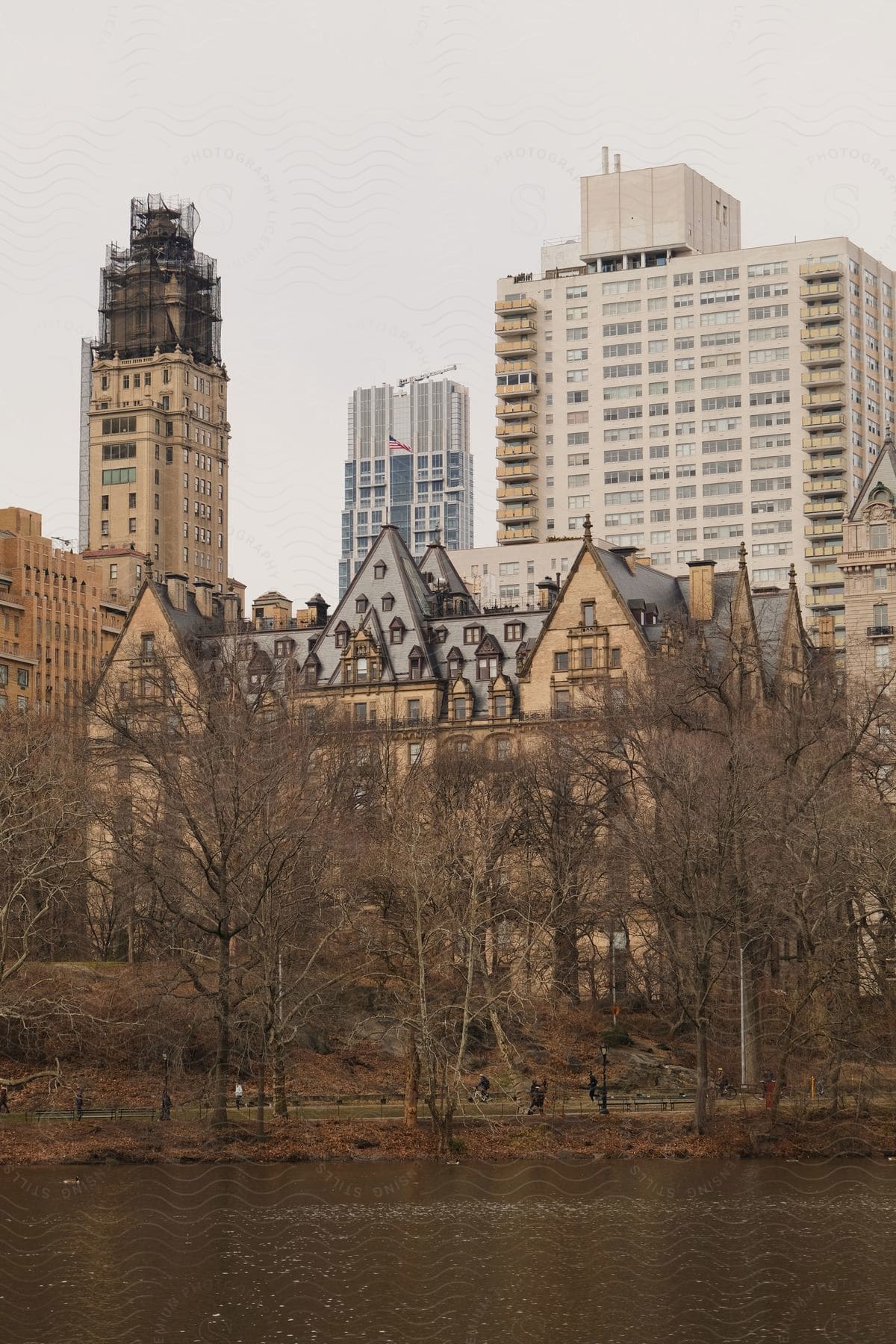 A small group of people in an urban cityscape with water and architectural buildings