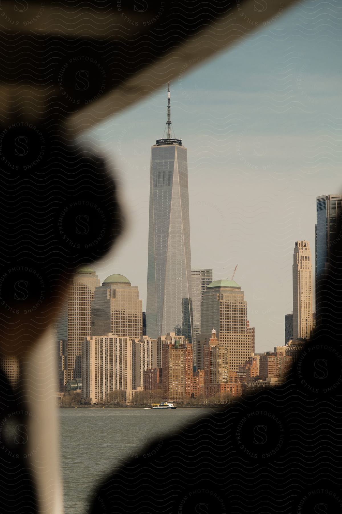 A cityscape with tall skyscrapers and ships on the waterfront