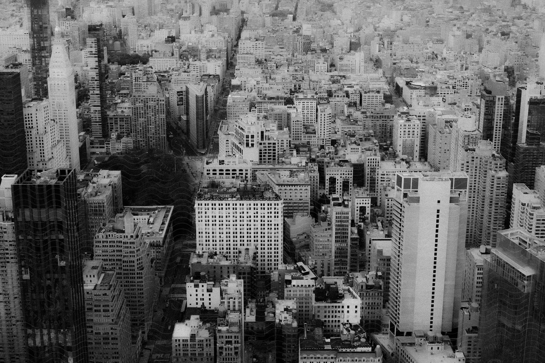 A black and white aerial view of urban buildings in a cityscape