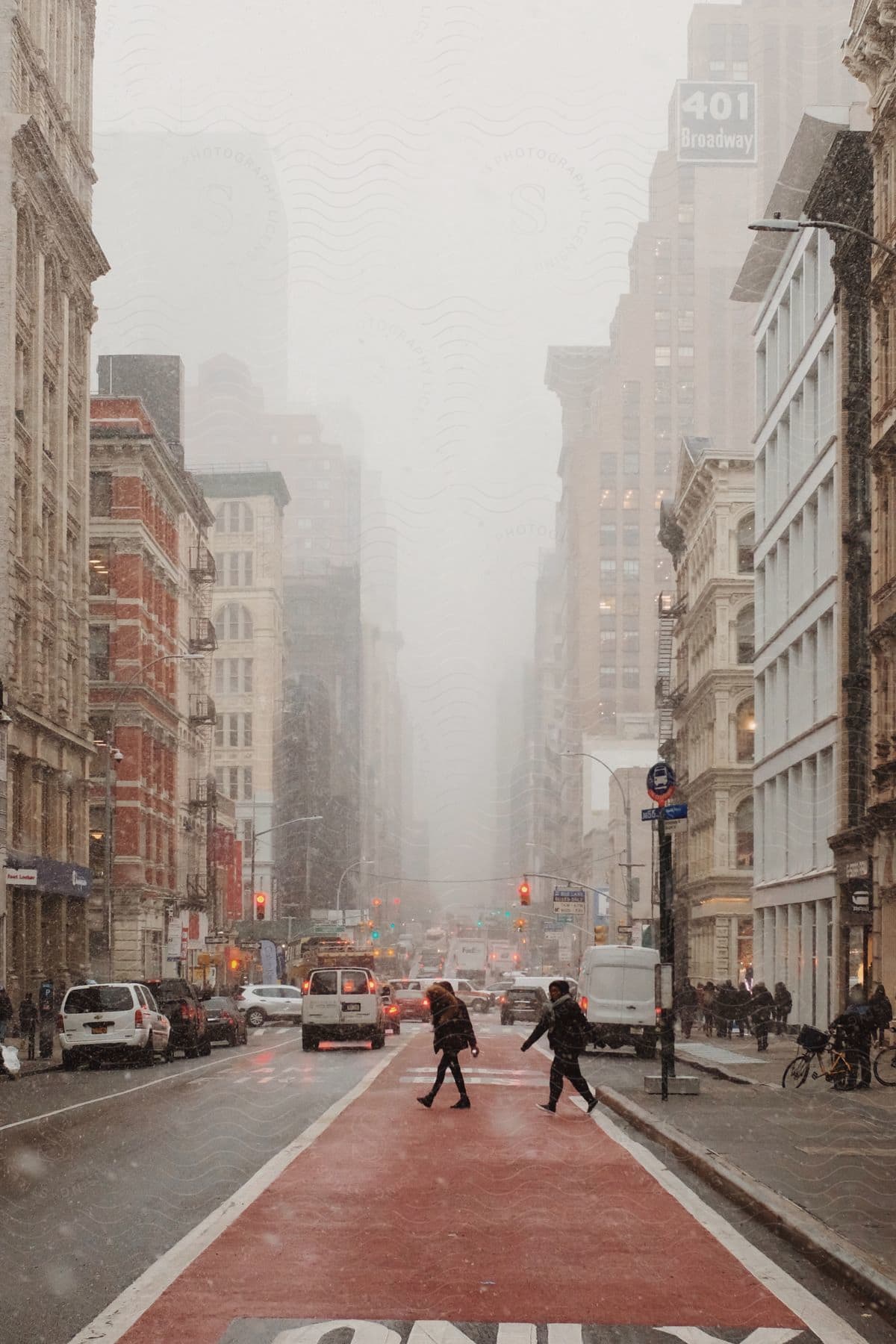 A foggy morning in downtown manhattan with skyscrapers buildings and a crowded street