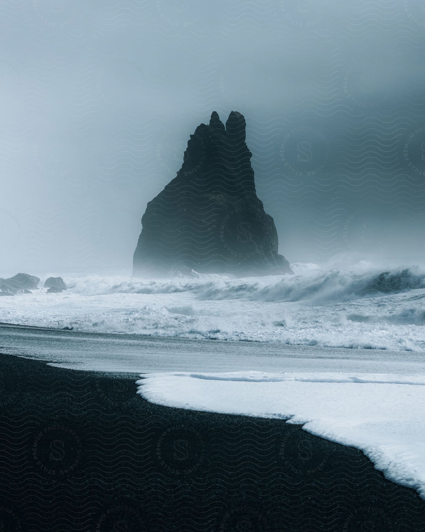 Sea stack on a cloudy beach