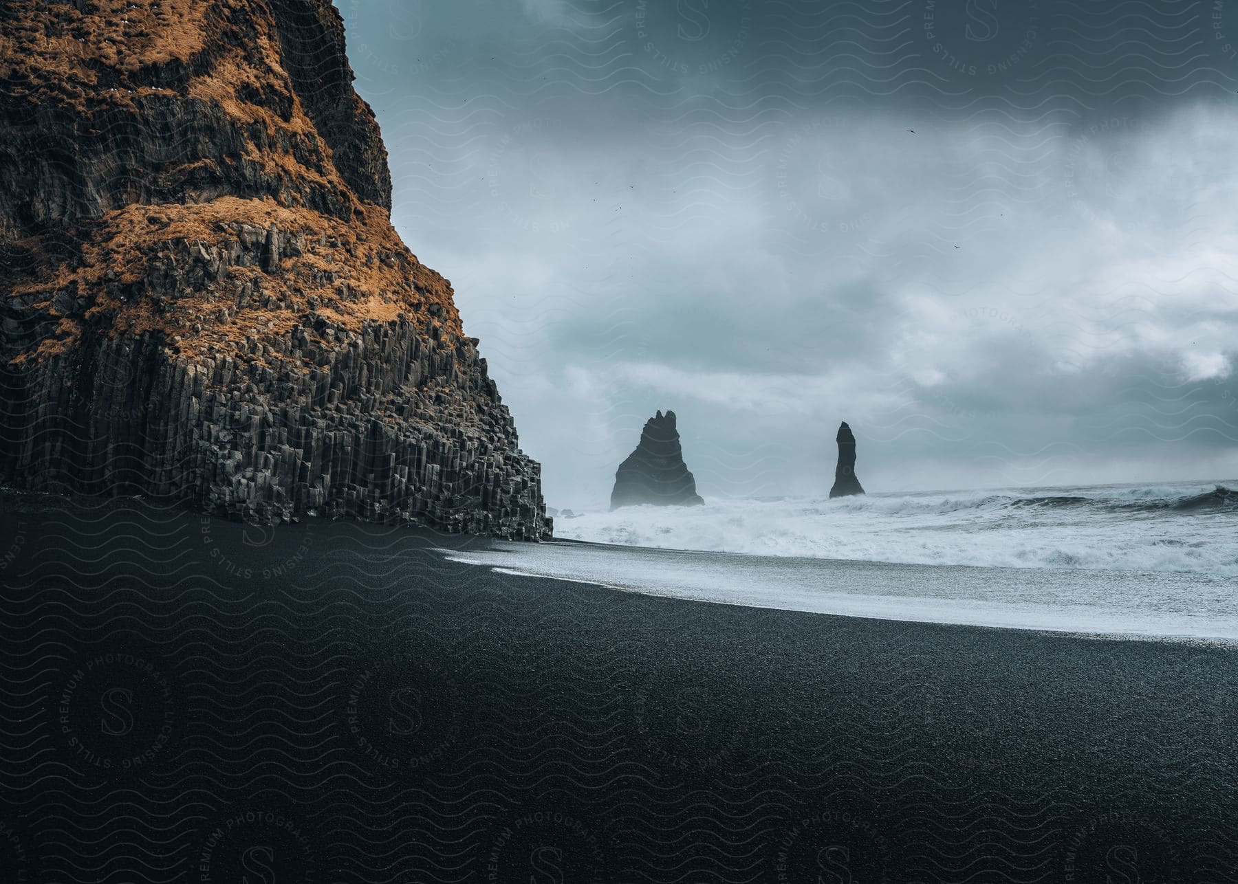 Beach with massive rocks and cloudy sky