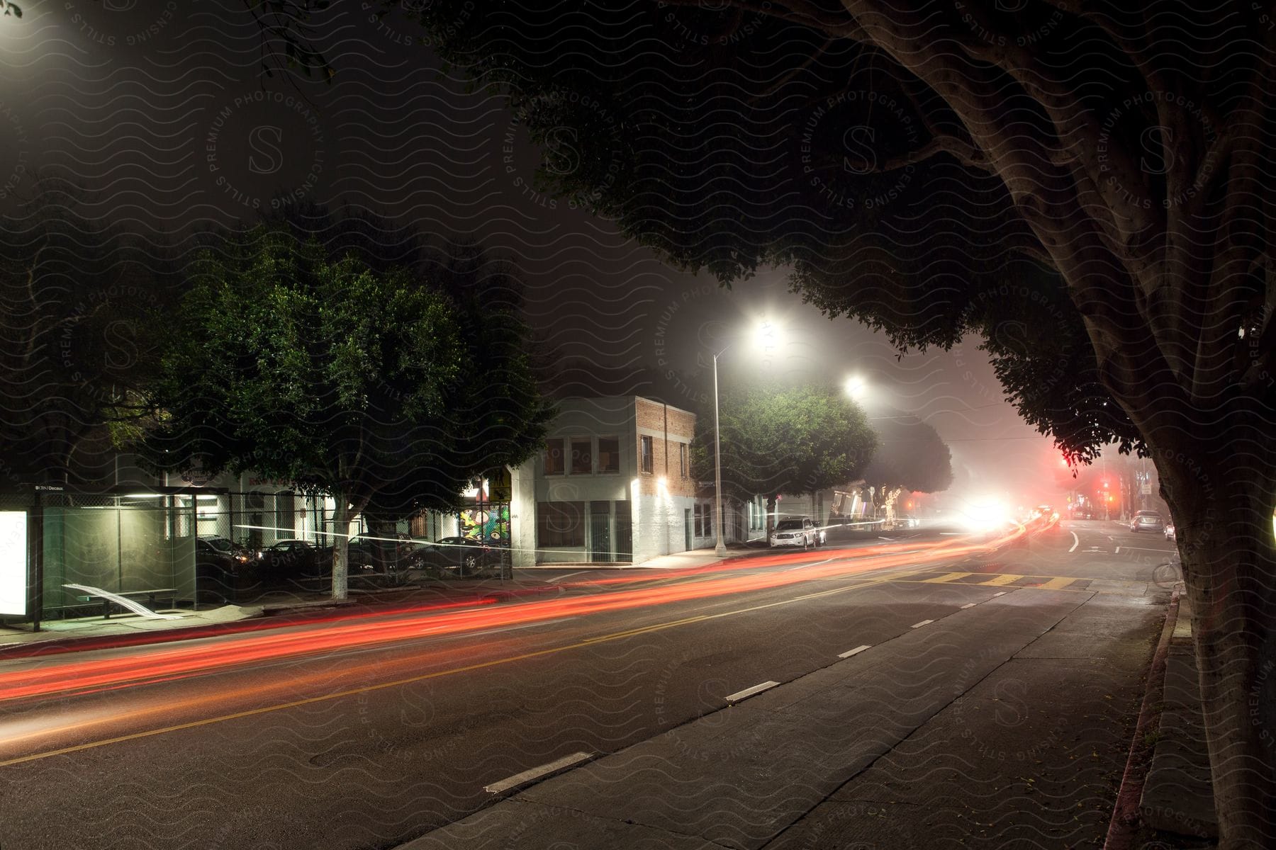 A bustling city street at night with various lights