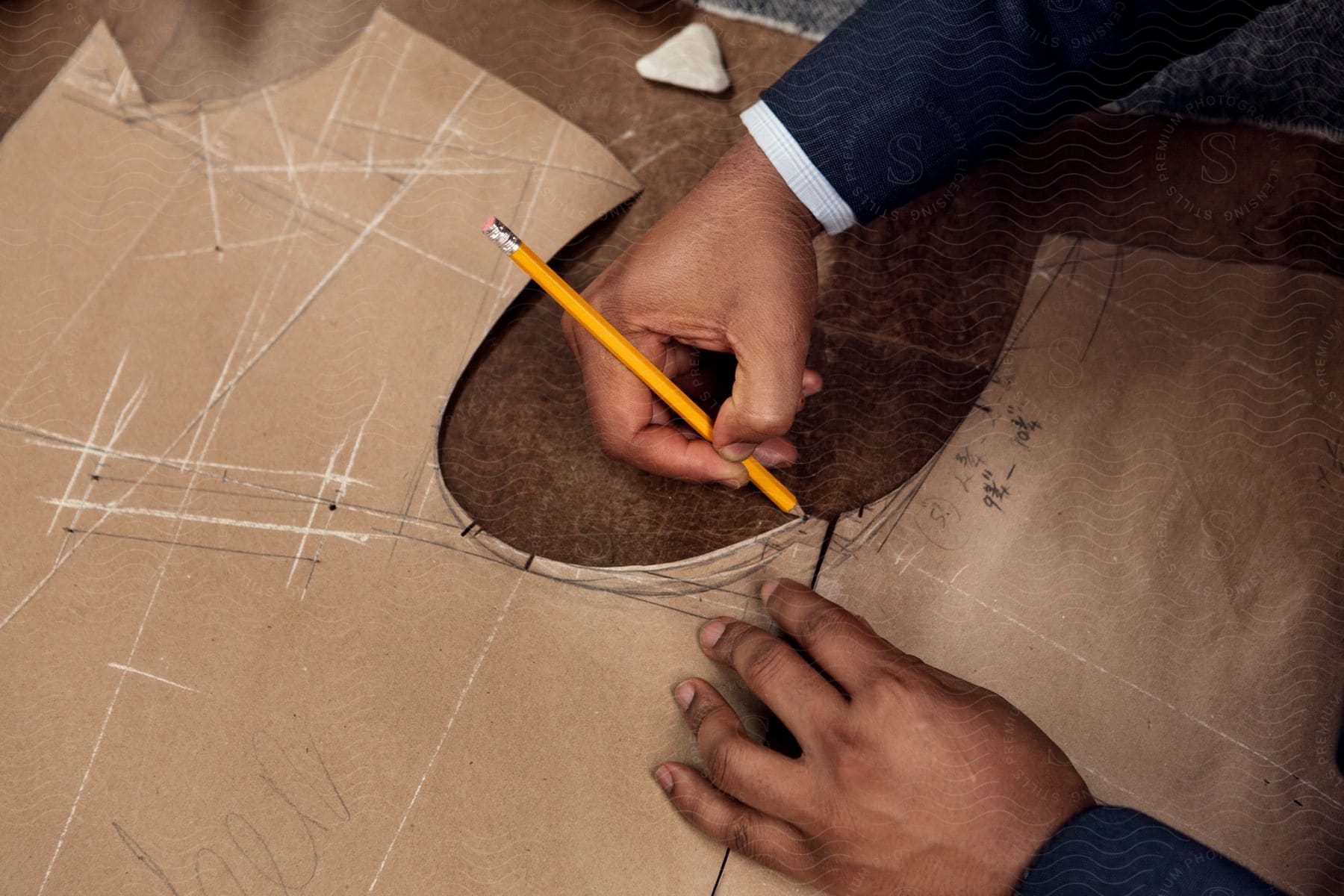 A workman taking measurement on a cardboard