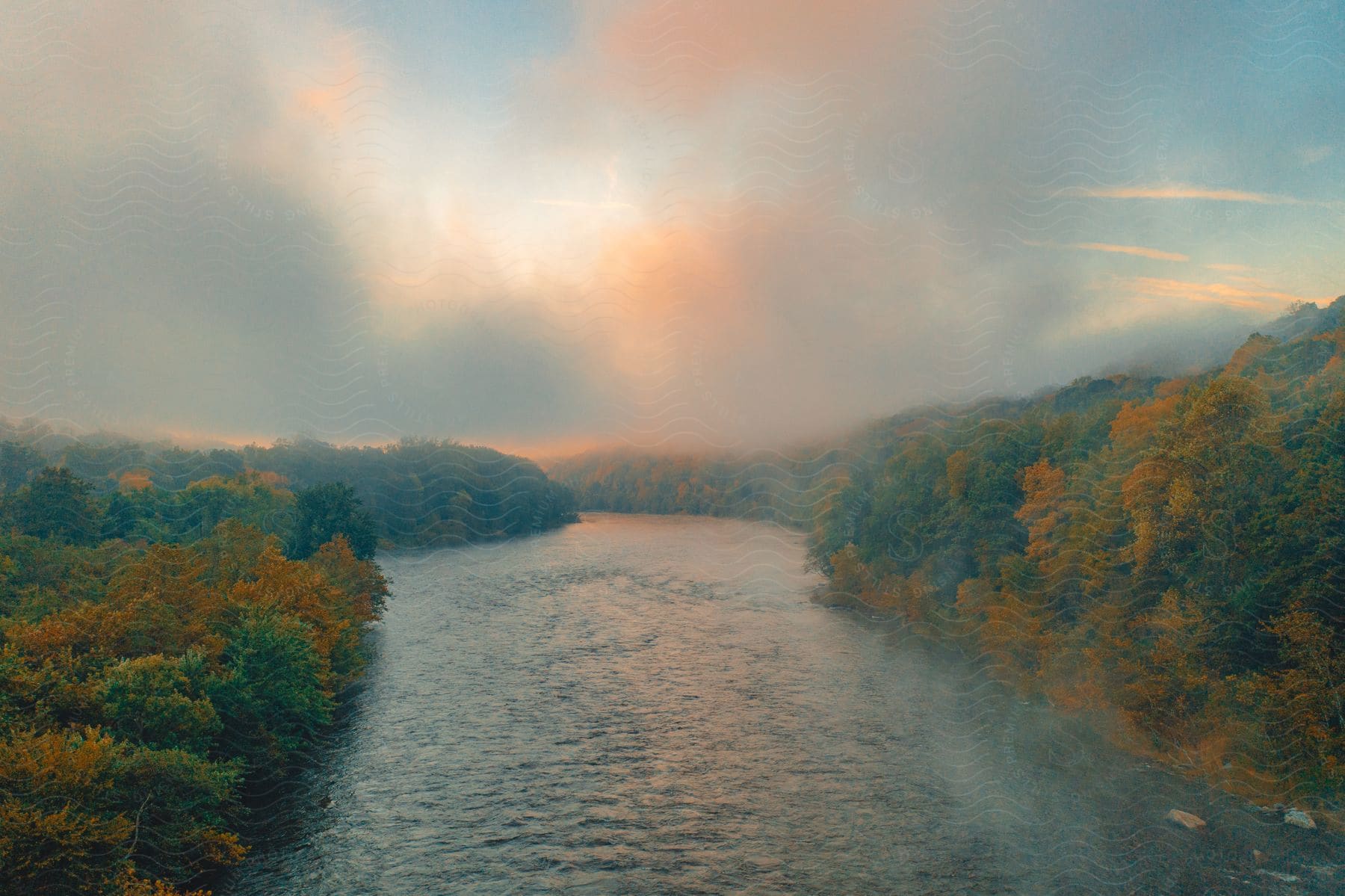 The sun is setting above a river