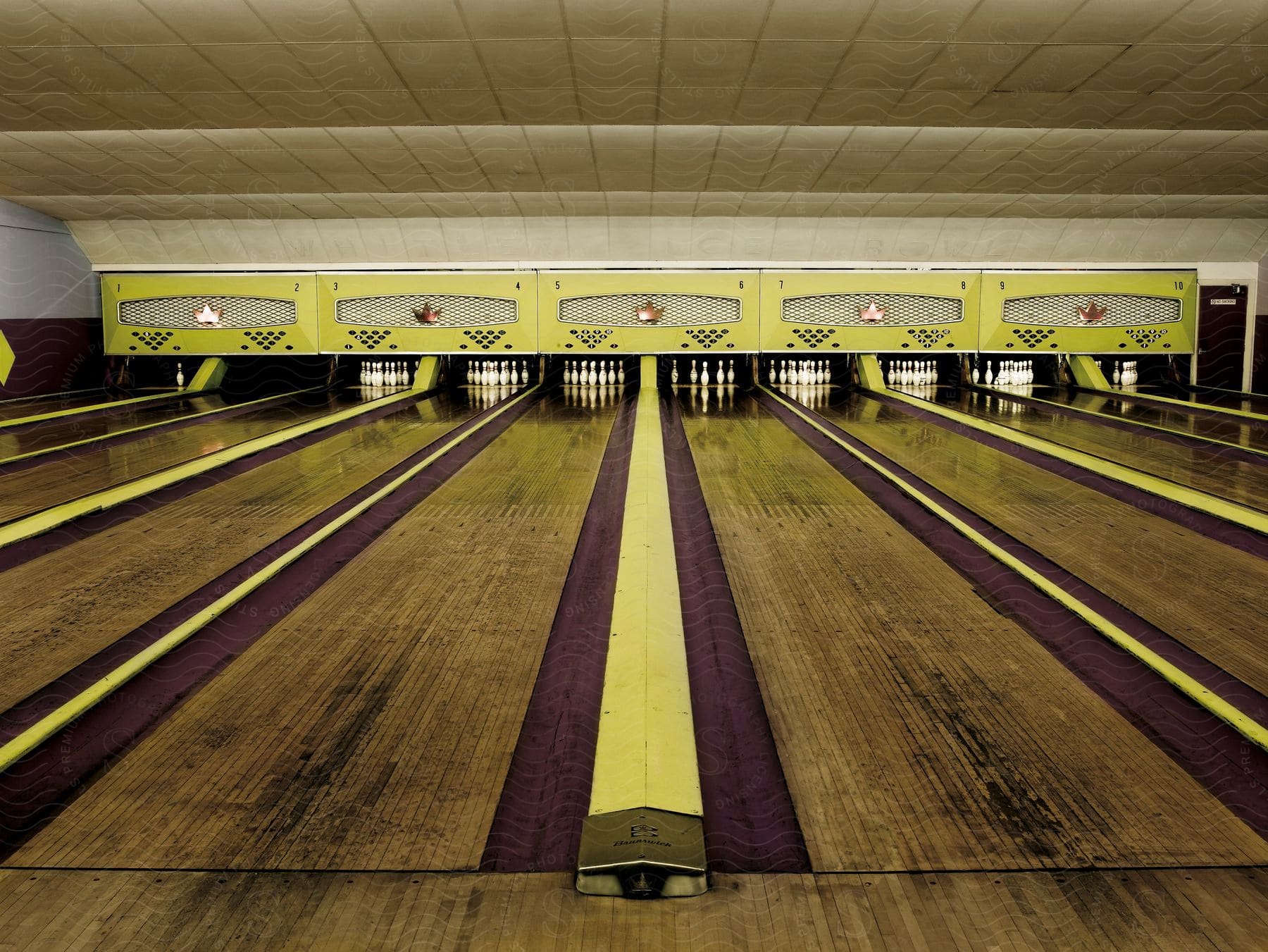 An unoccupied bowling alley with no bowling balls