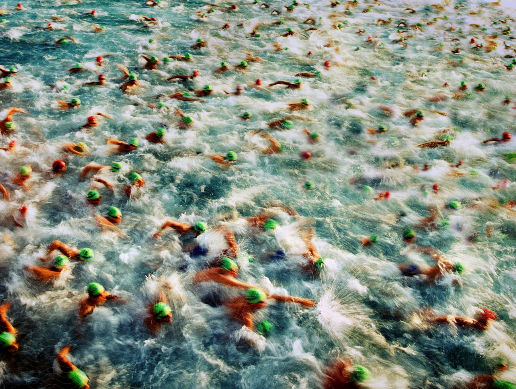 Large group of swimmers swimming across the ocean water