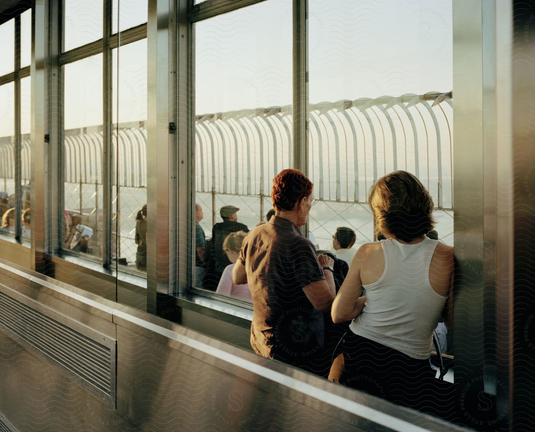 Tourists on a skywalk admiring the city view