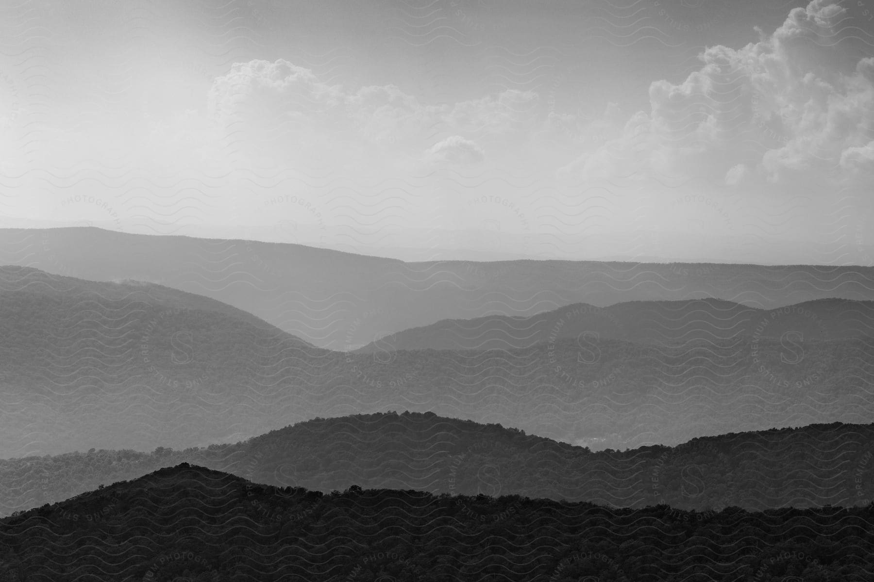 Black and white photo of distant mountains and clouds