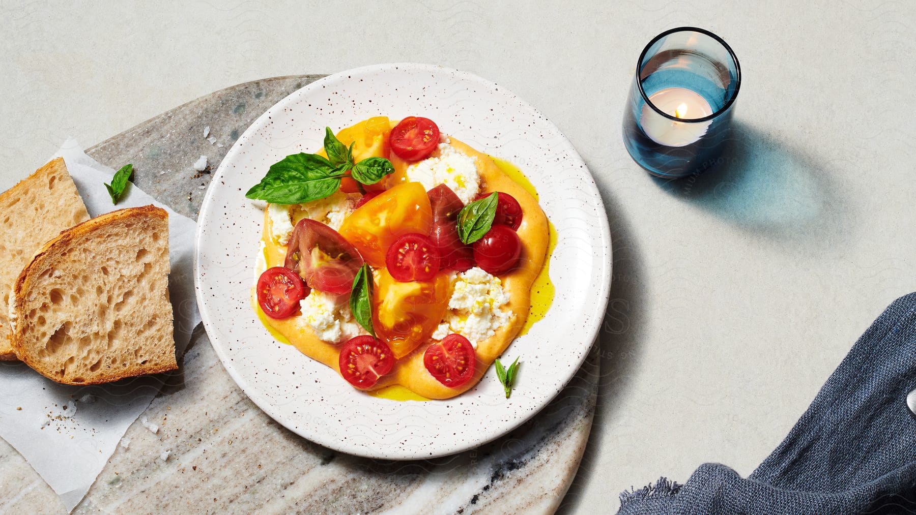 A caprese salad and bread on a serving tray