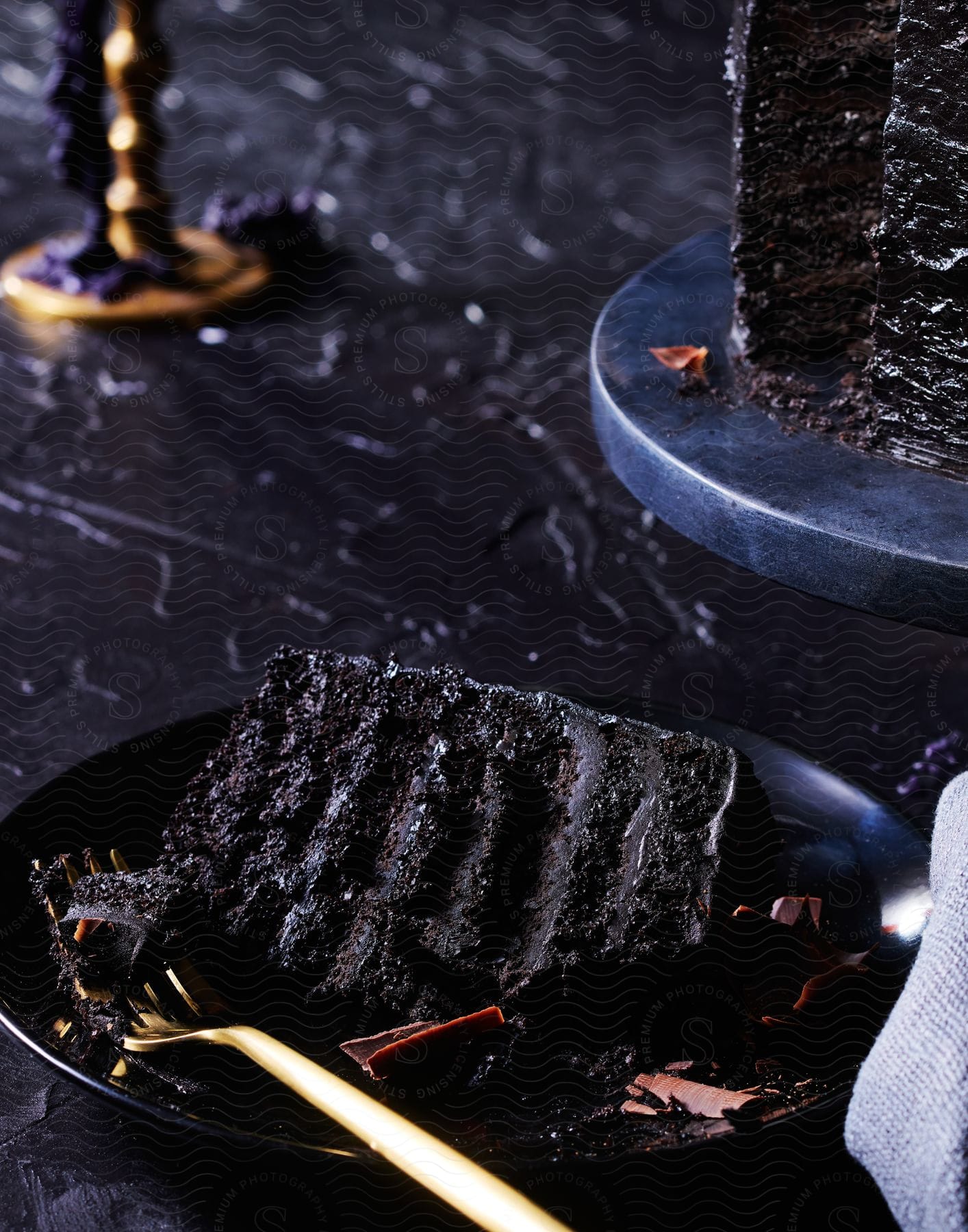 A chocolate cake on a black plate