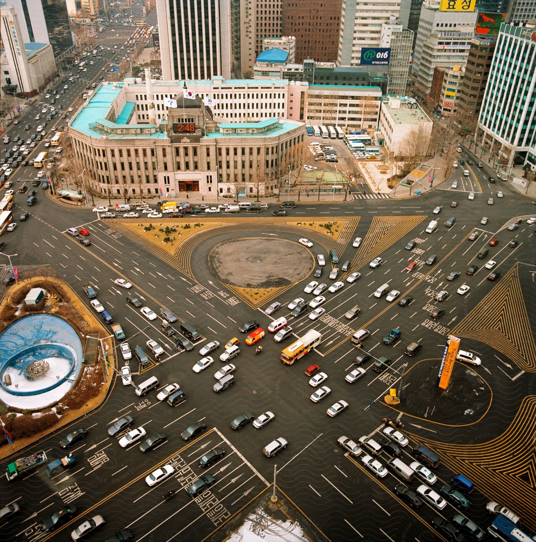 Traffic on a crossing next to buildings and skyscrapers