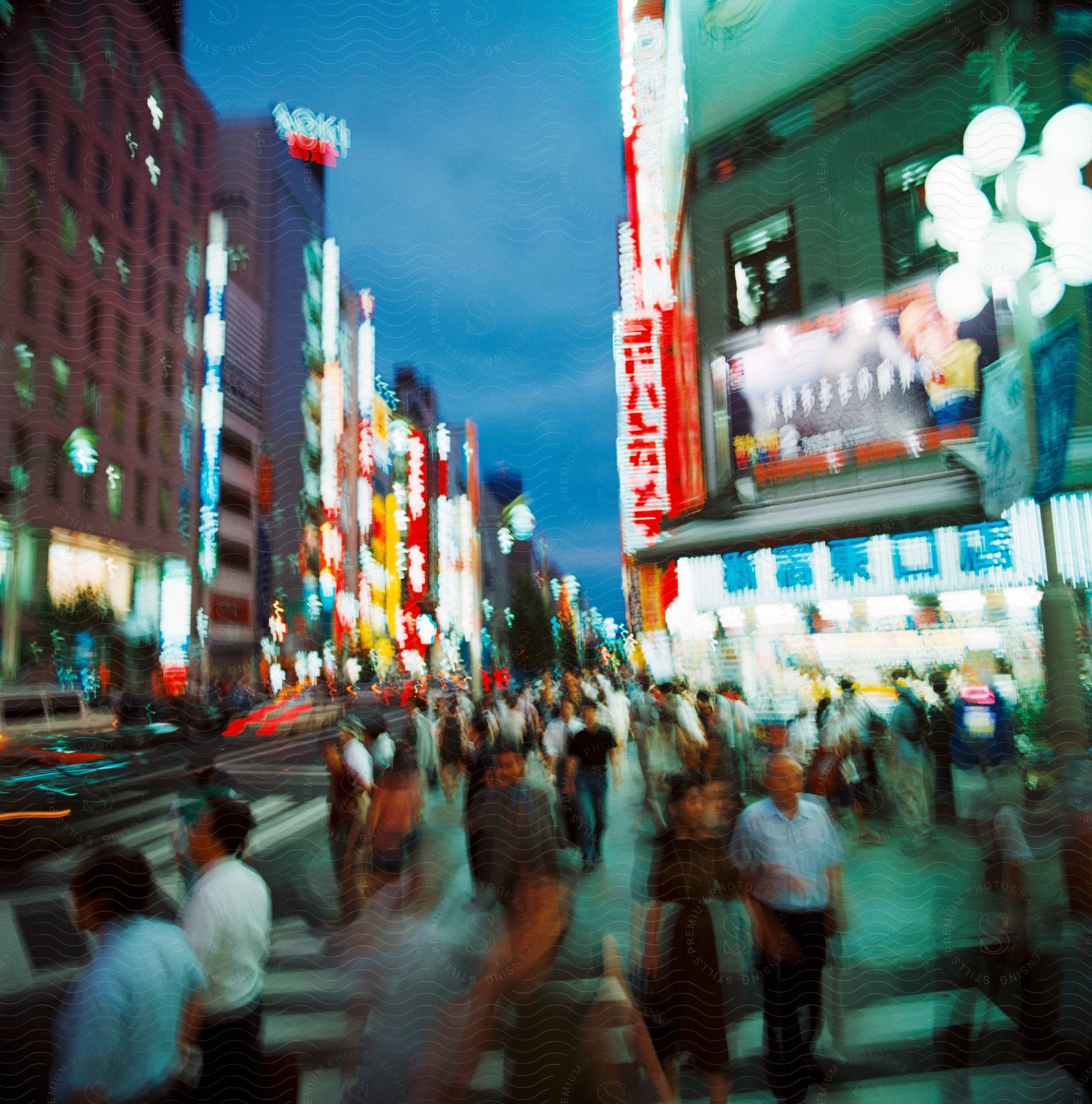 Chaotic street of a major asian city crowded with people lights and neon lights