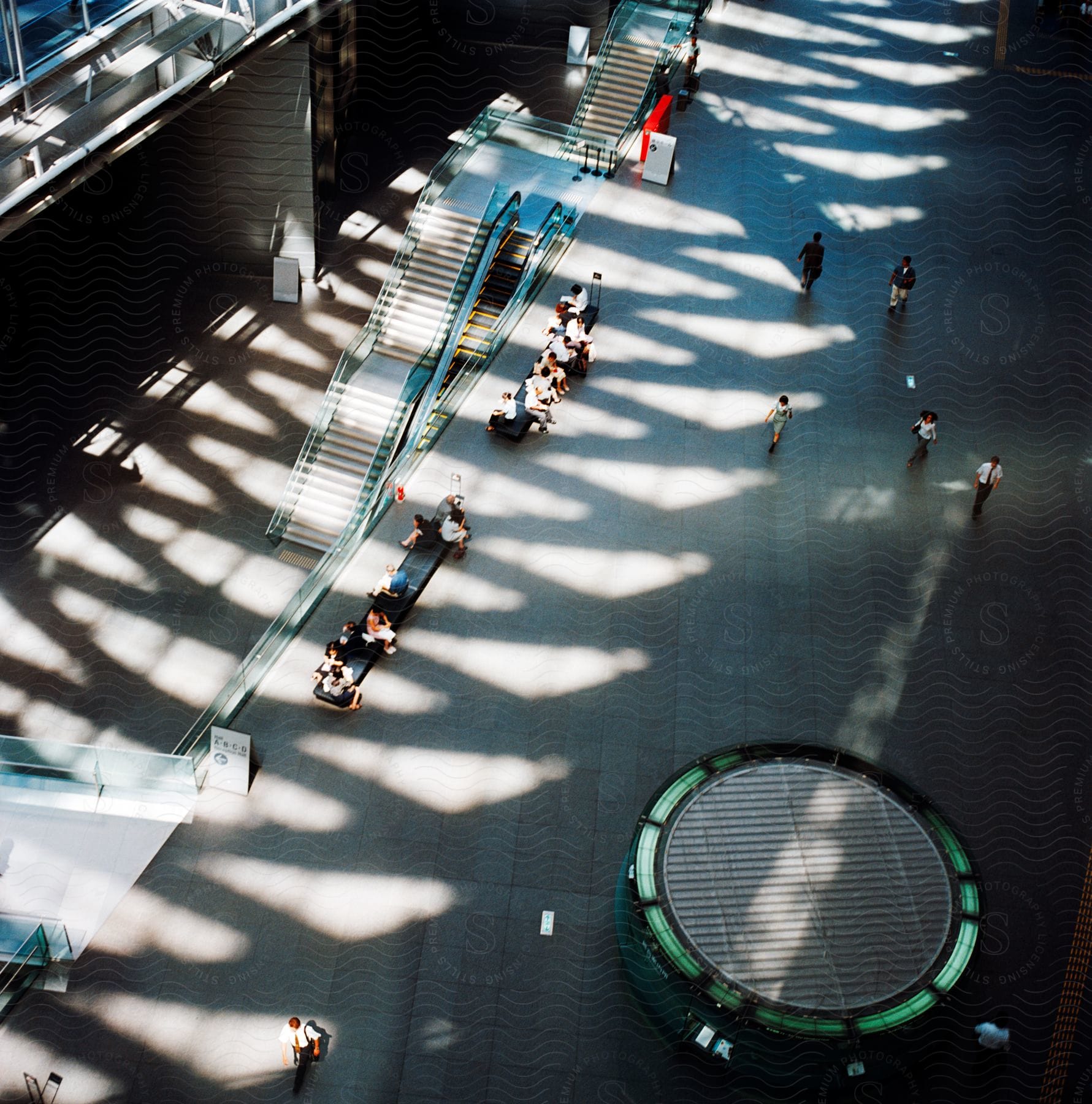 People waiting on benches in a large modern atrium in tokyo