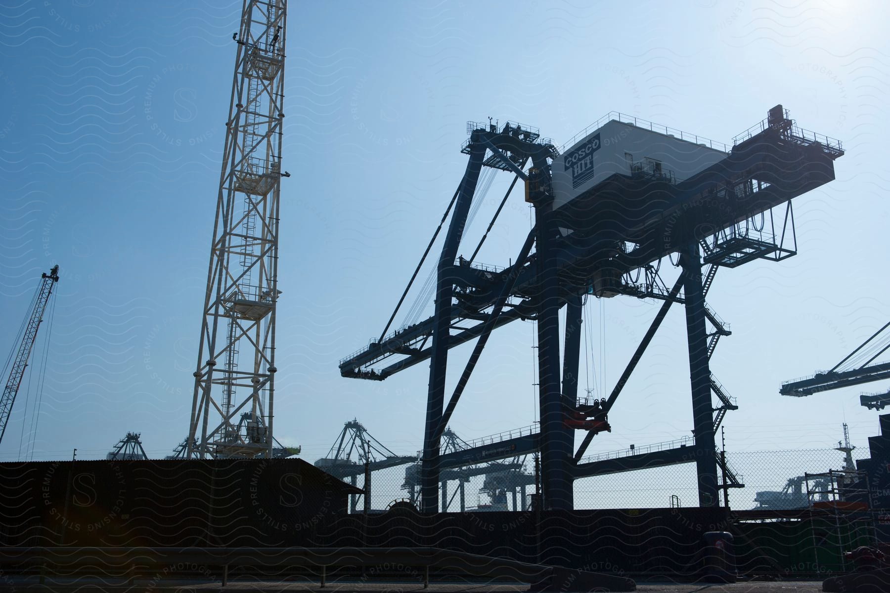 Construction crane against a sky backdrop near a waterfront