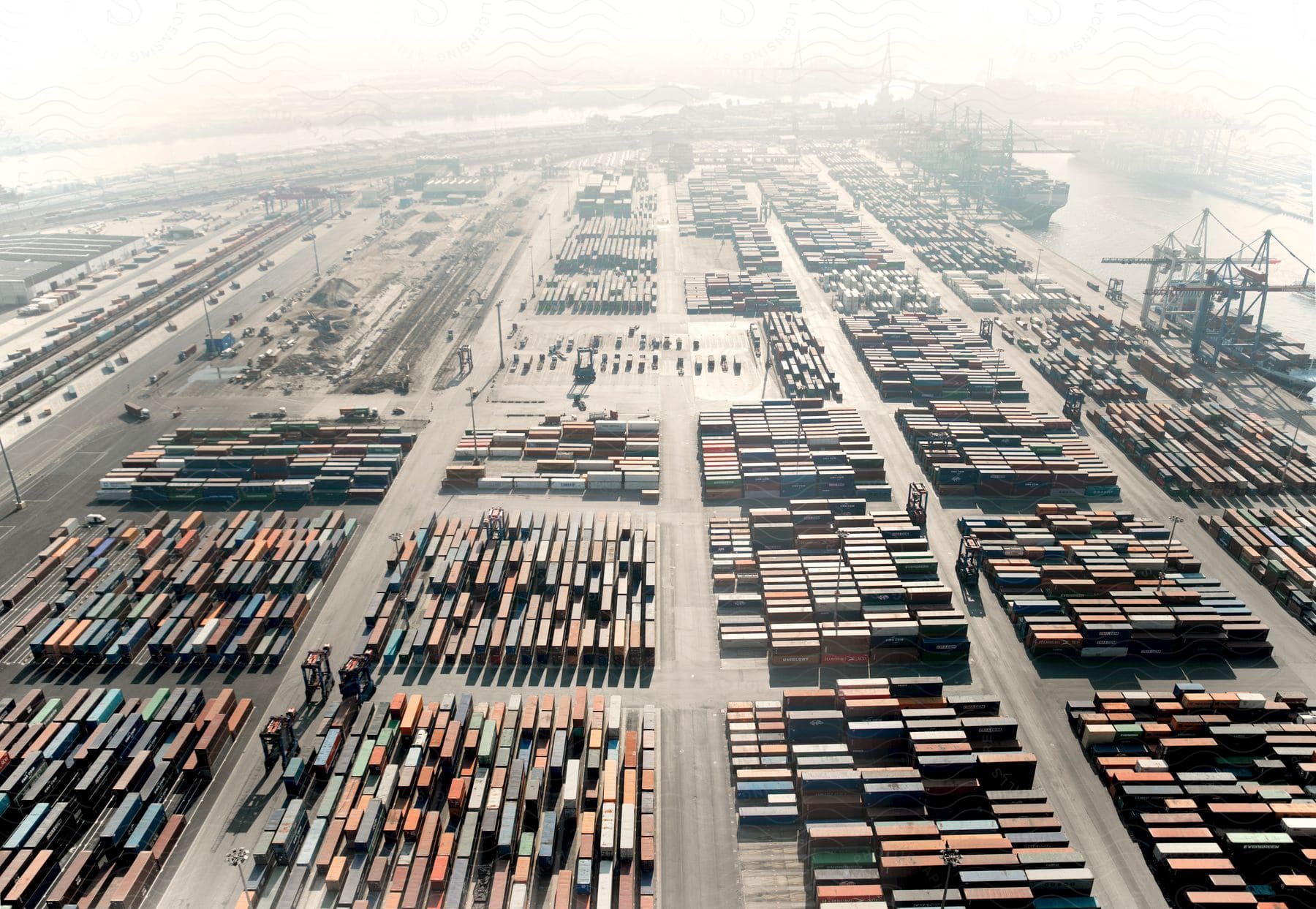 A sea port with numerous cargo containers and a freight ship