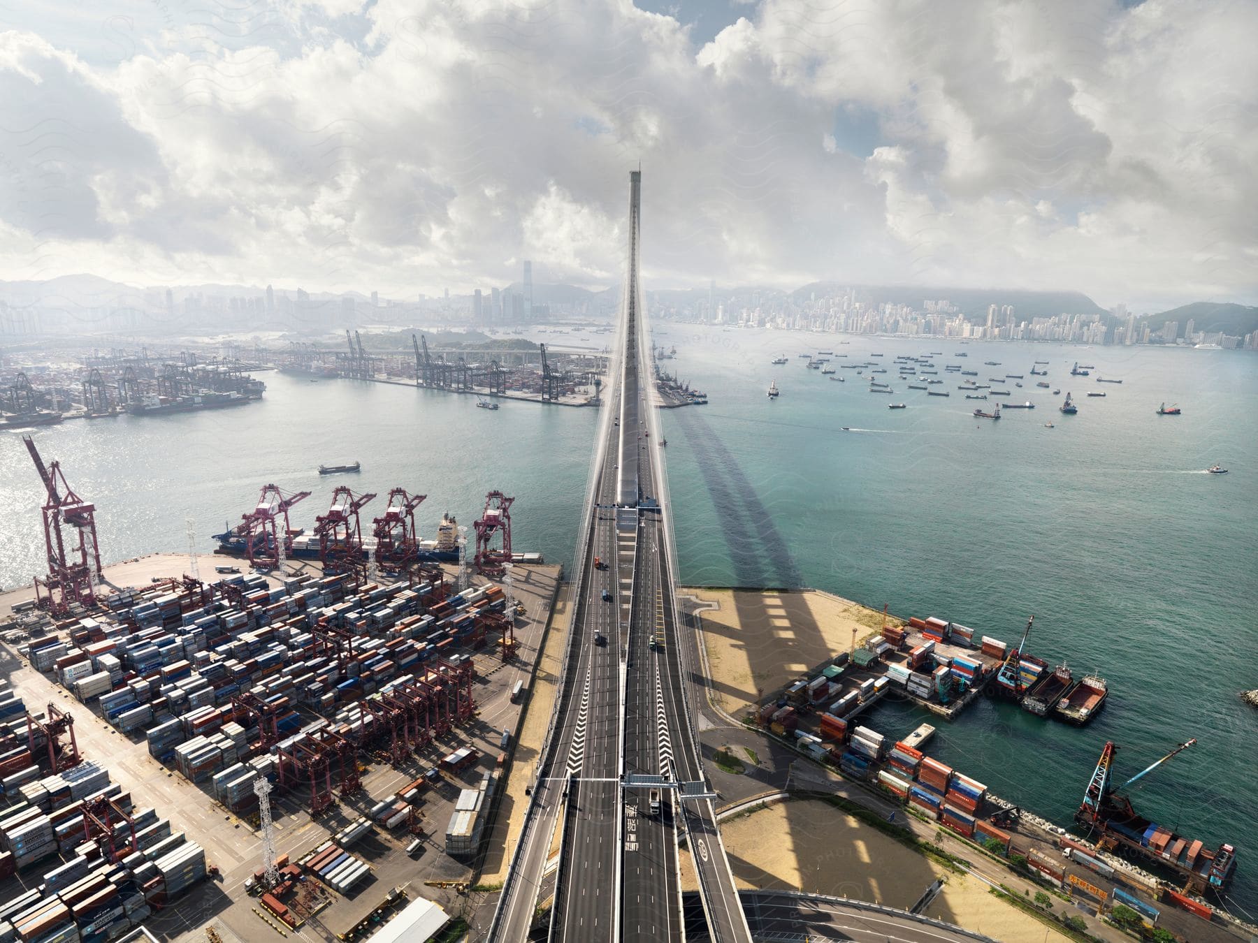 A bridge crossing over a shipyard and harbor towards a city